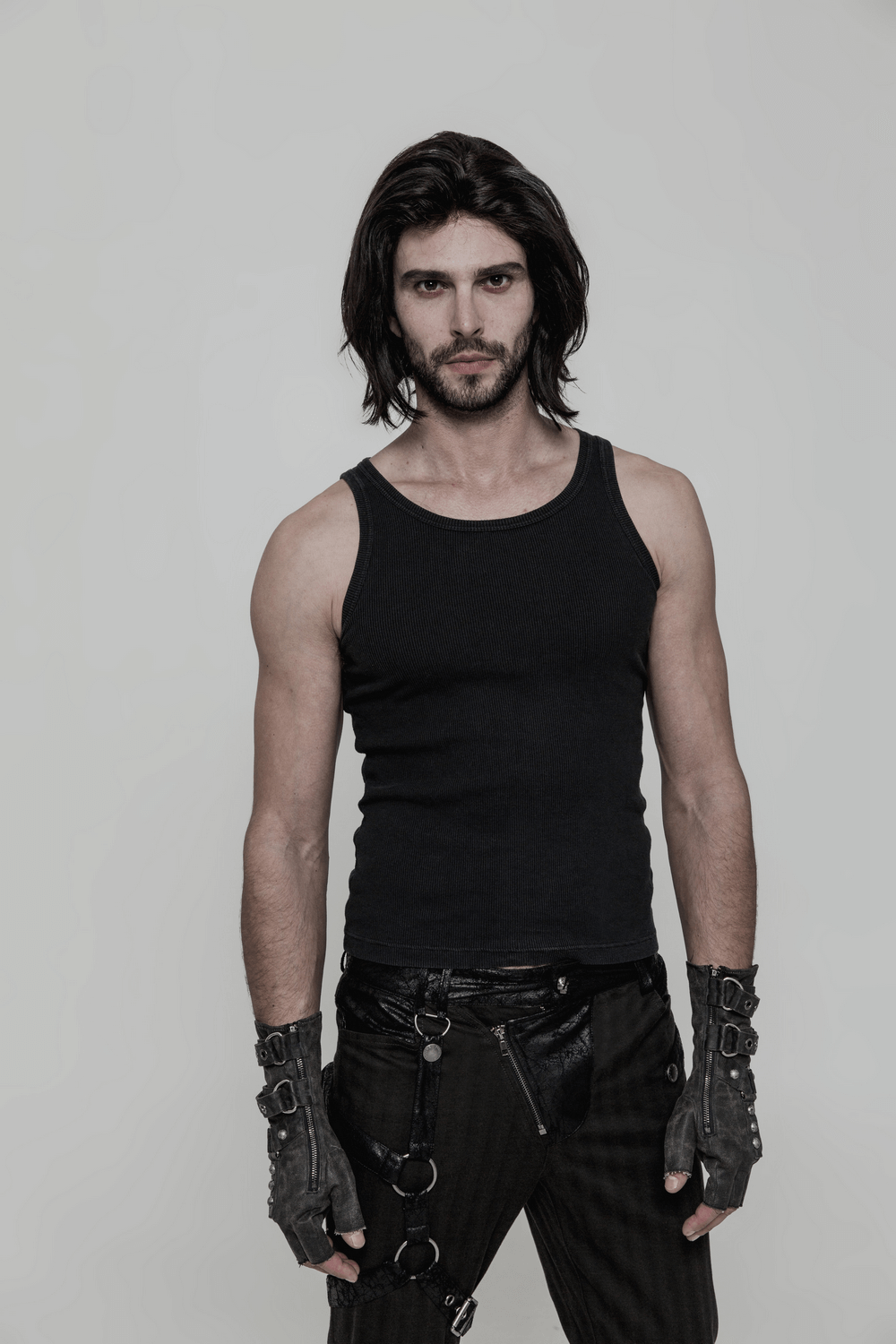 Man wearing durable steampunk-style leather gauntlet gloves and black tank top, showcasing edgy fashion.
