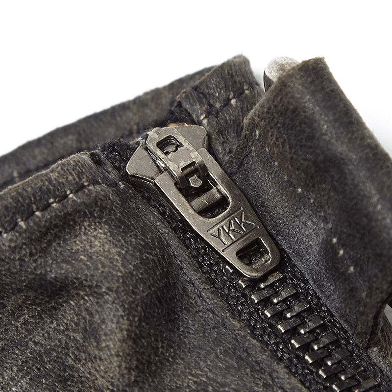 Close-up of side zipper on durable steampunk-style leather gauntlet gloves for easy wear.