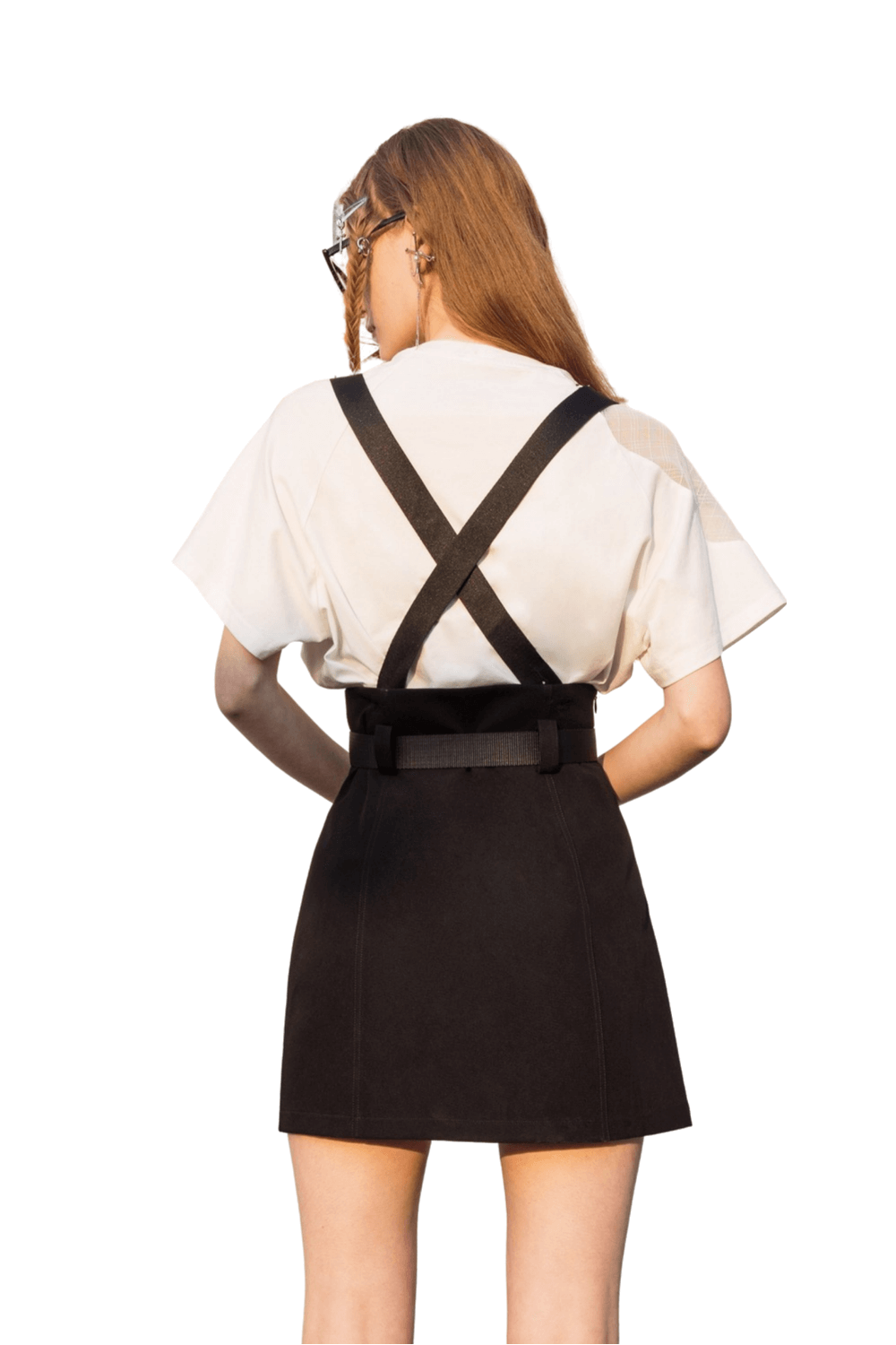 Back view of a model wearing an edgy A-line mini skirt with detachable chain straps and a stylish belt.