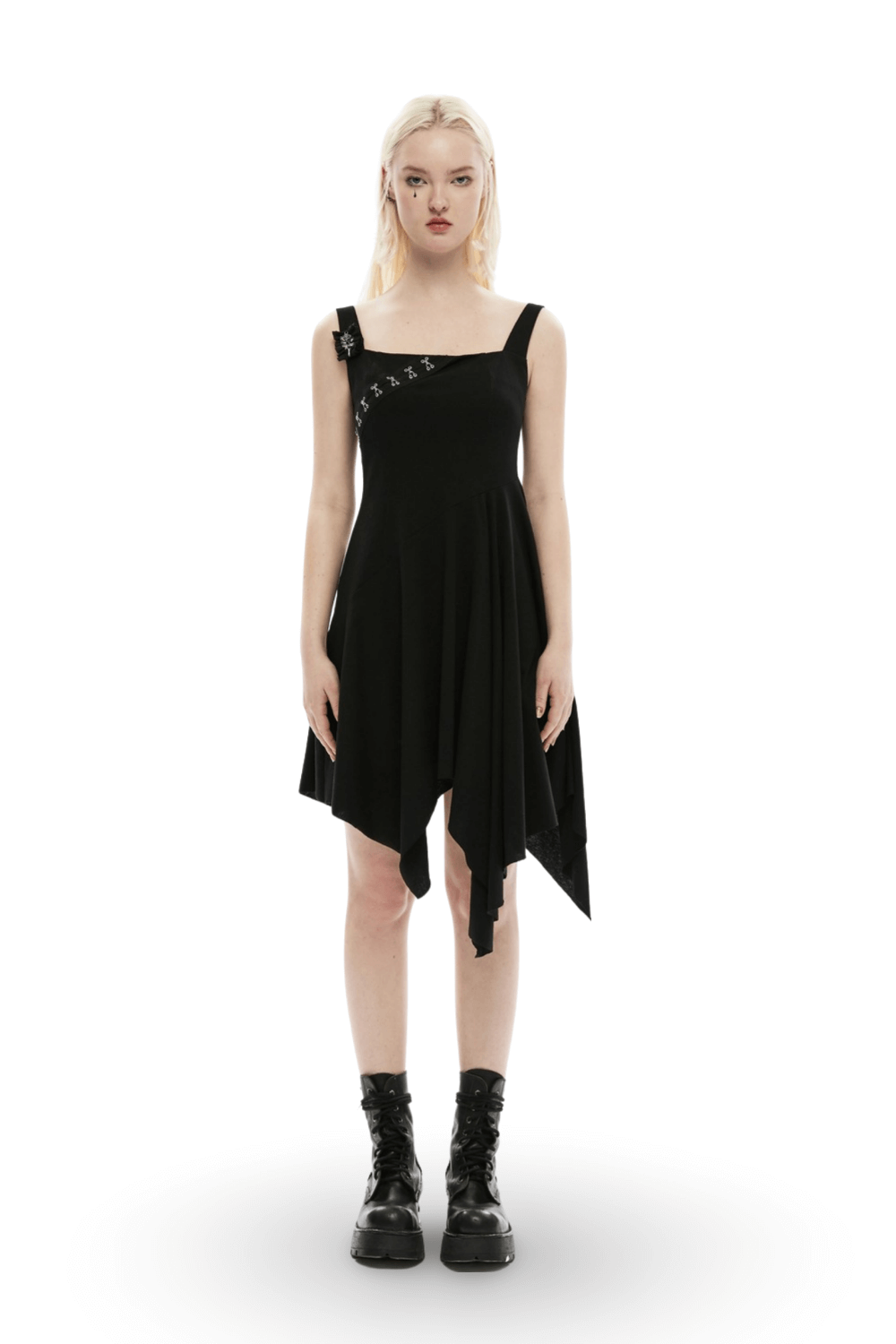 Edgy asymmetrical black slip dress with brooch detail, featuring a square hemline and stylish embellishments.