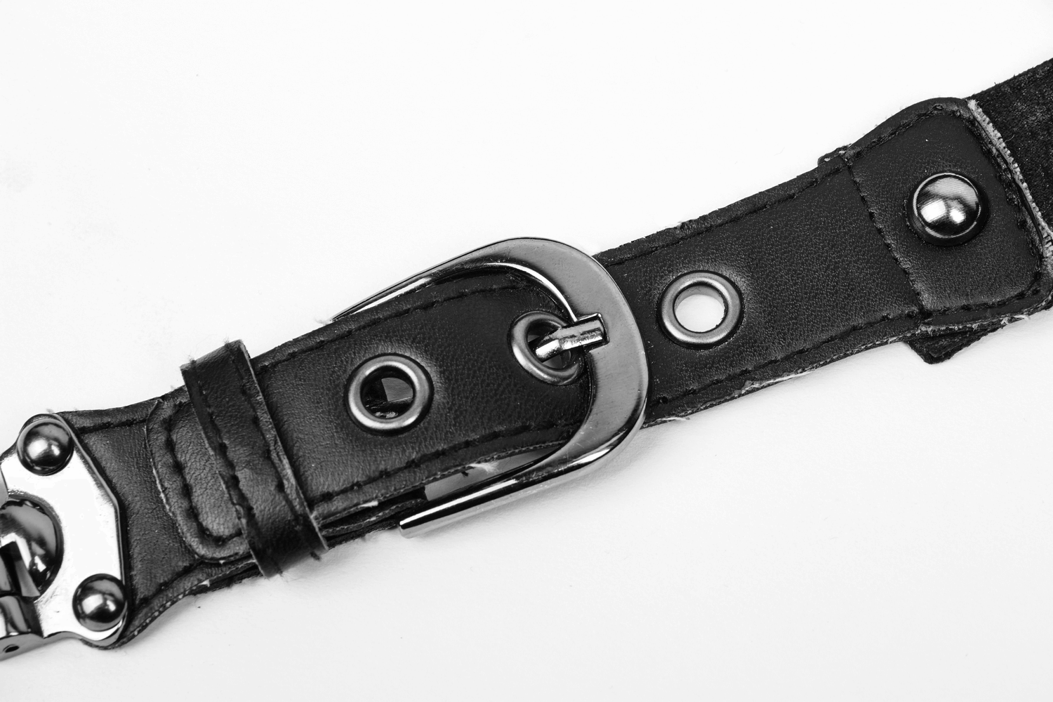 Close-up of a black leather belt with metal buckle and decorative studs, perfect for gothic or edgy fashion styles.