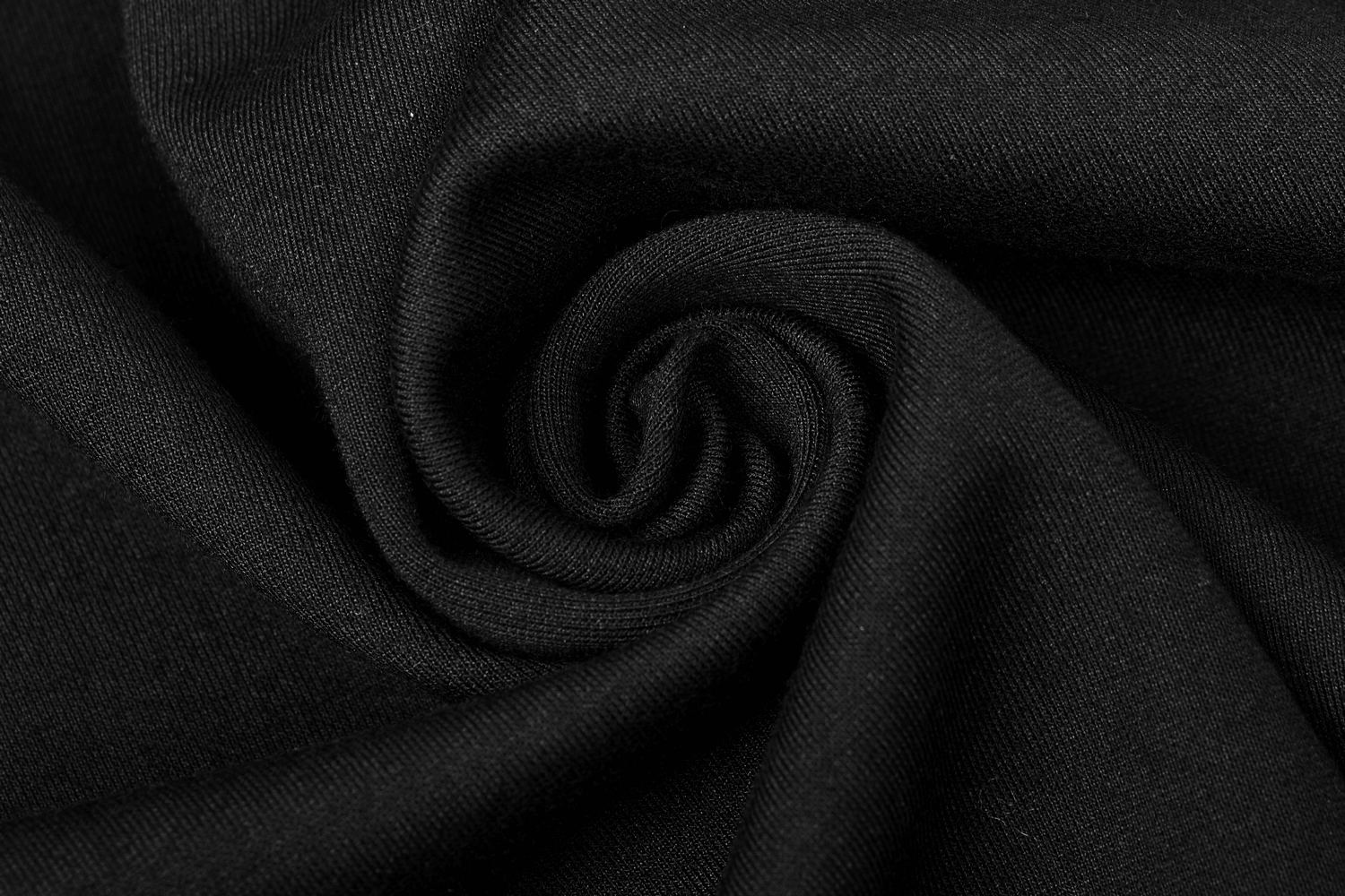 Close-up of soft black fabric, perfect for creating stylish and edgy garments like capes and cloaks.