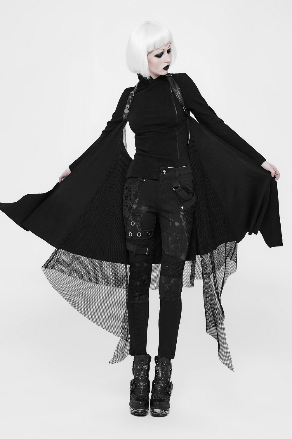 Edgy black asymmetrical cape with lace trim on a model, showcasing gothic fashion and bold style.