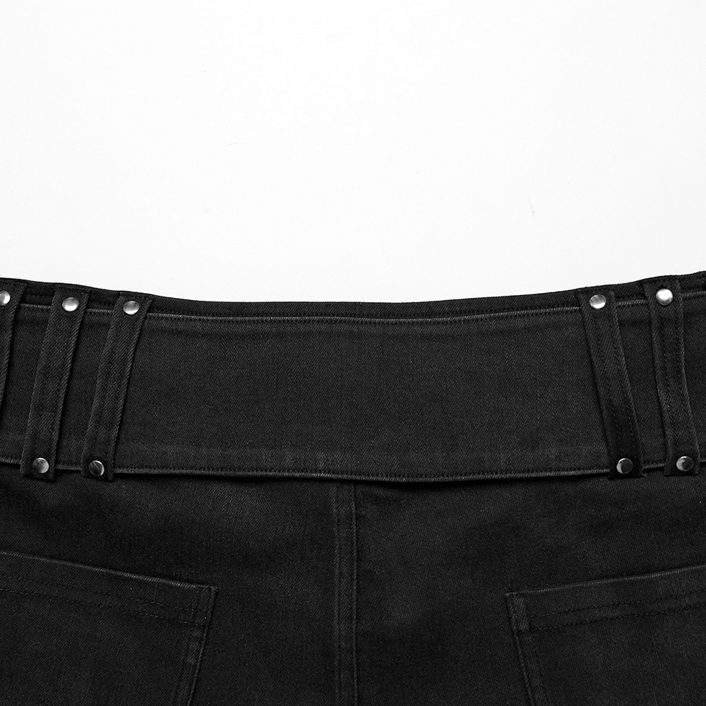 Close-up of edgy black denim shorts waist with adjustable metal buckle and unique belt design.
