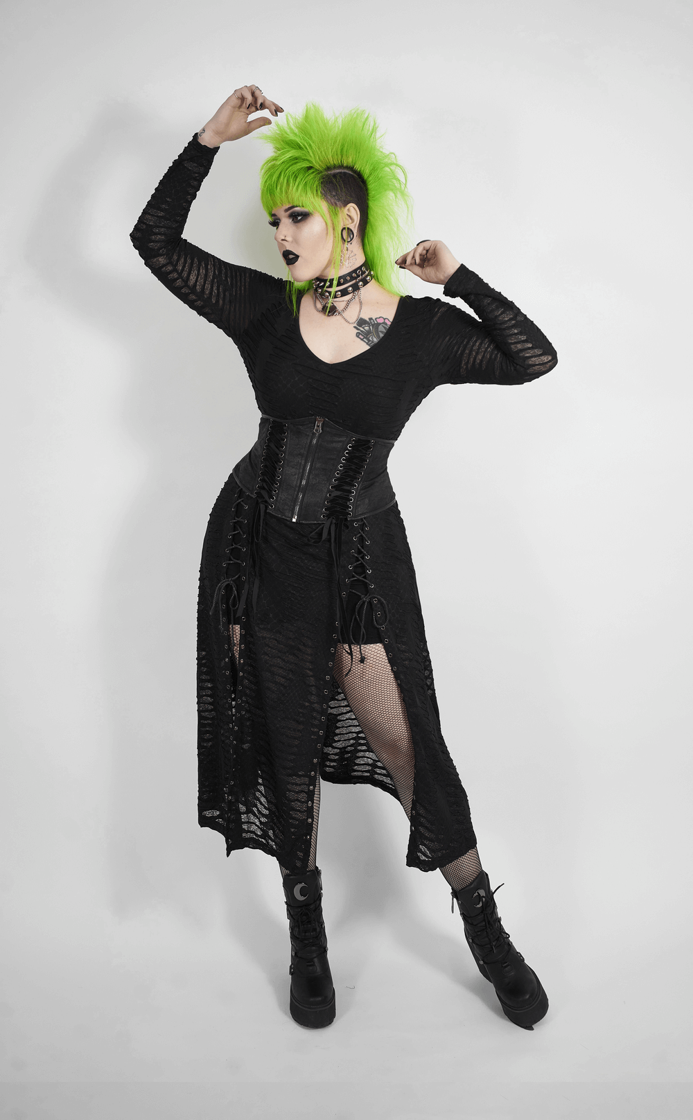 Edgy black gothic corset belt with lace-up details, worn by model with bright green hair and stylish black outfit.