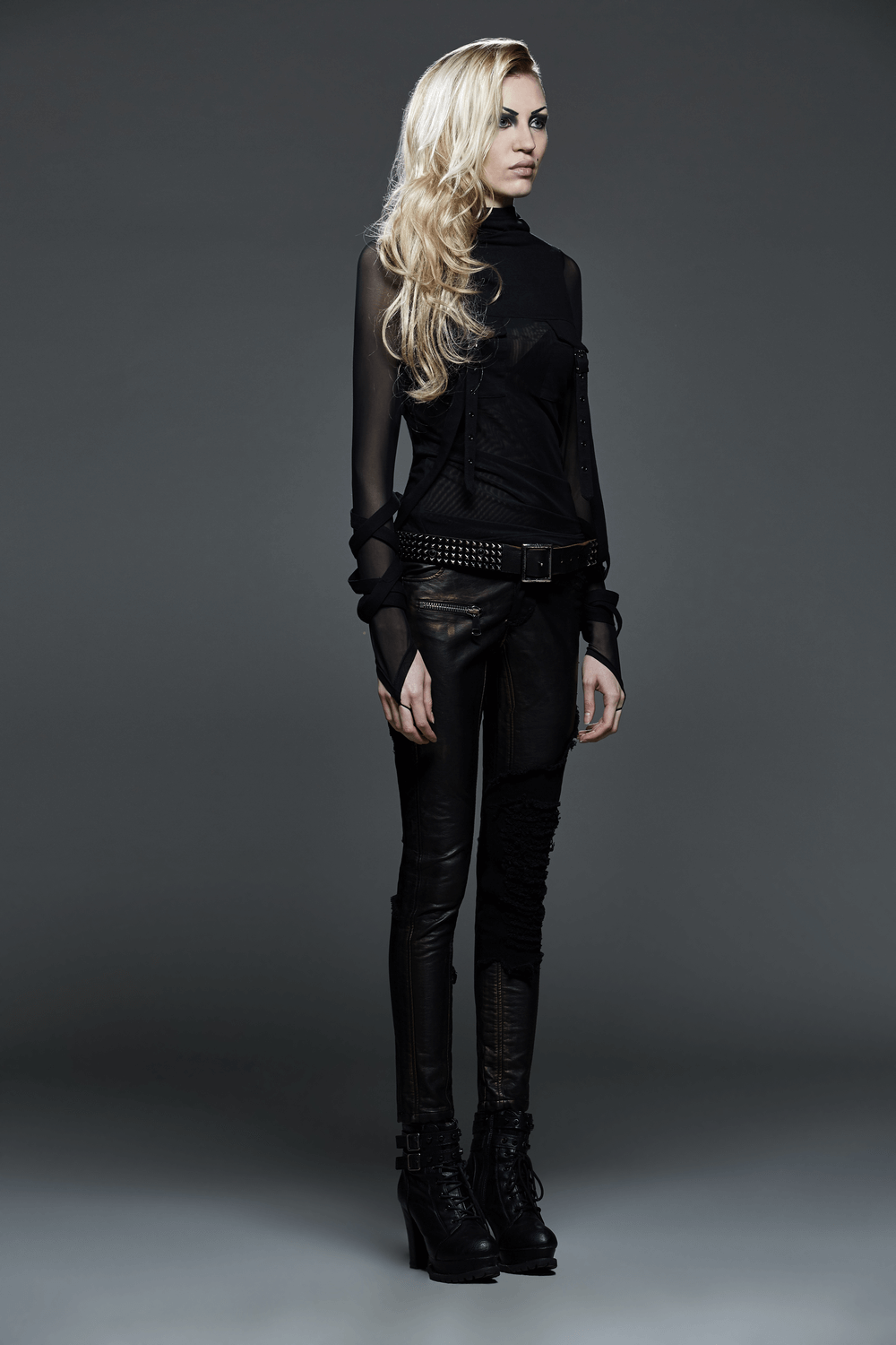 Edgy black hooded top with mesh sleeves and stylish black pants for women, showcasing modern fashion.