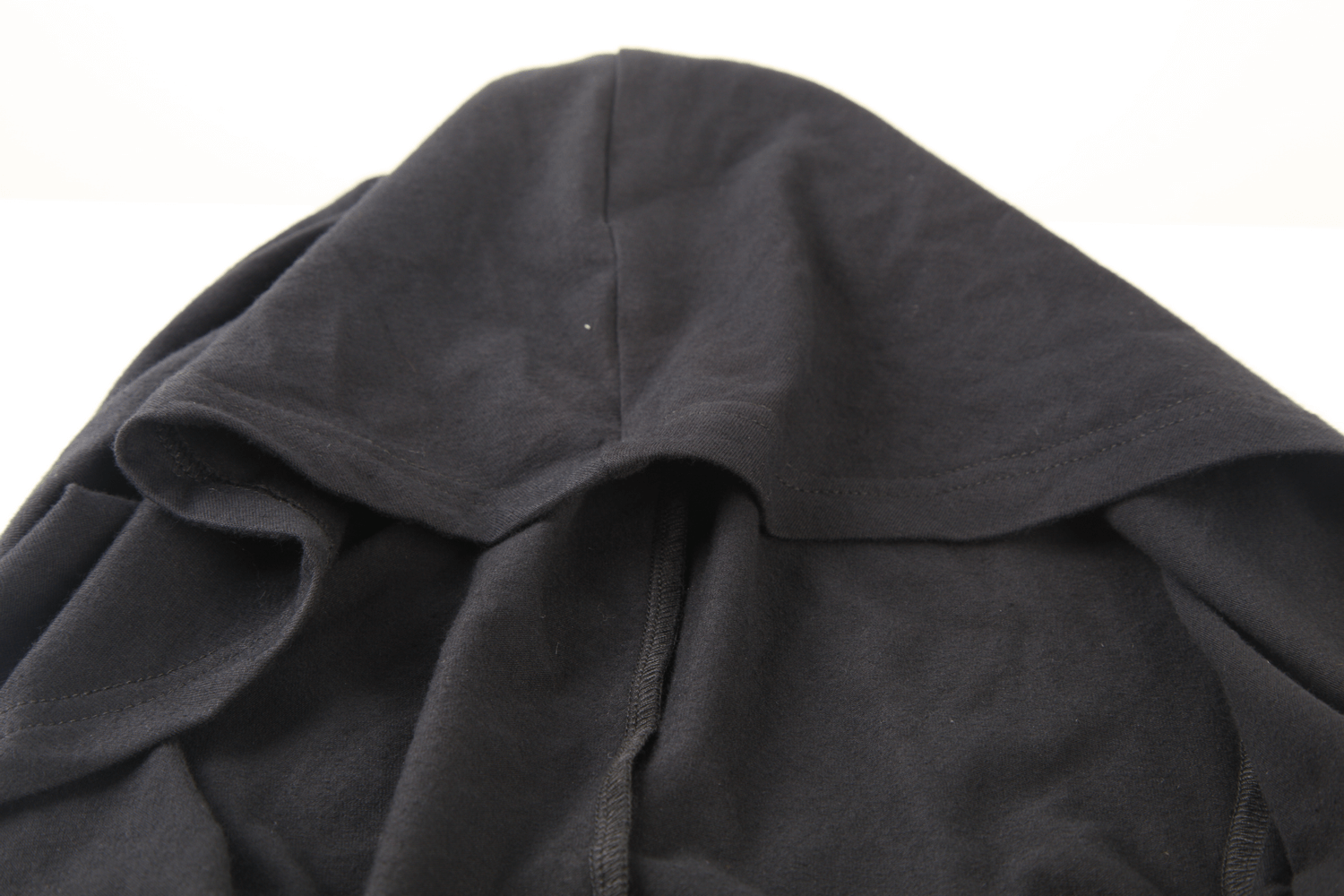 Close-up of a stylish black hooded top for women, featuring a chic design and soft fabric.