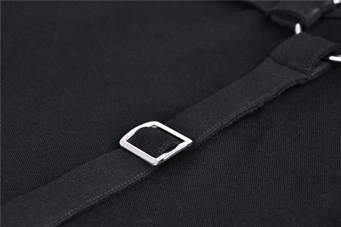 Close-up of metal accent buckle on edgy black hoodie with ripped details, showcasing punk-inspired design.
