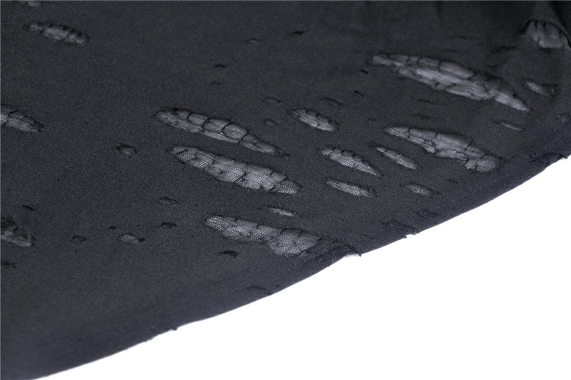 Close-up of edgy black hoodie fabric featuring ripped details and shredded texture for a punk-inspired look.