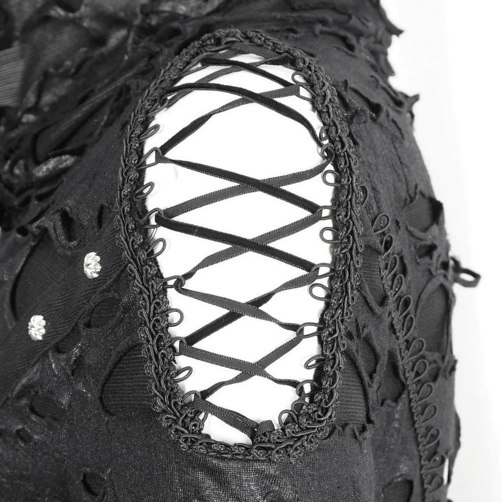 Close-up of distressed black fabric with laced sleeve design, showcasing gothic fashion details.