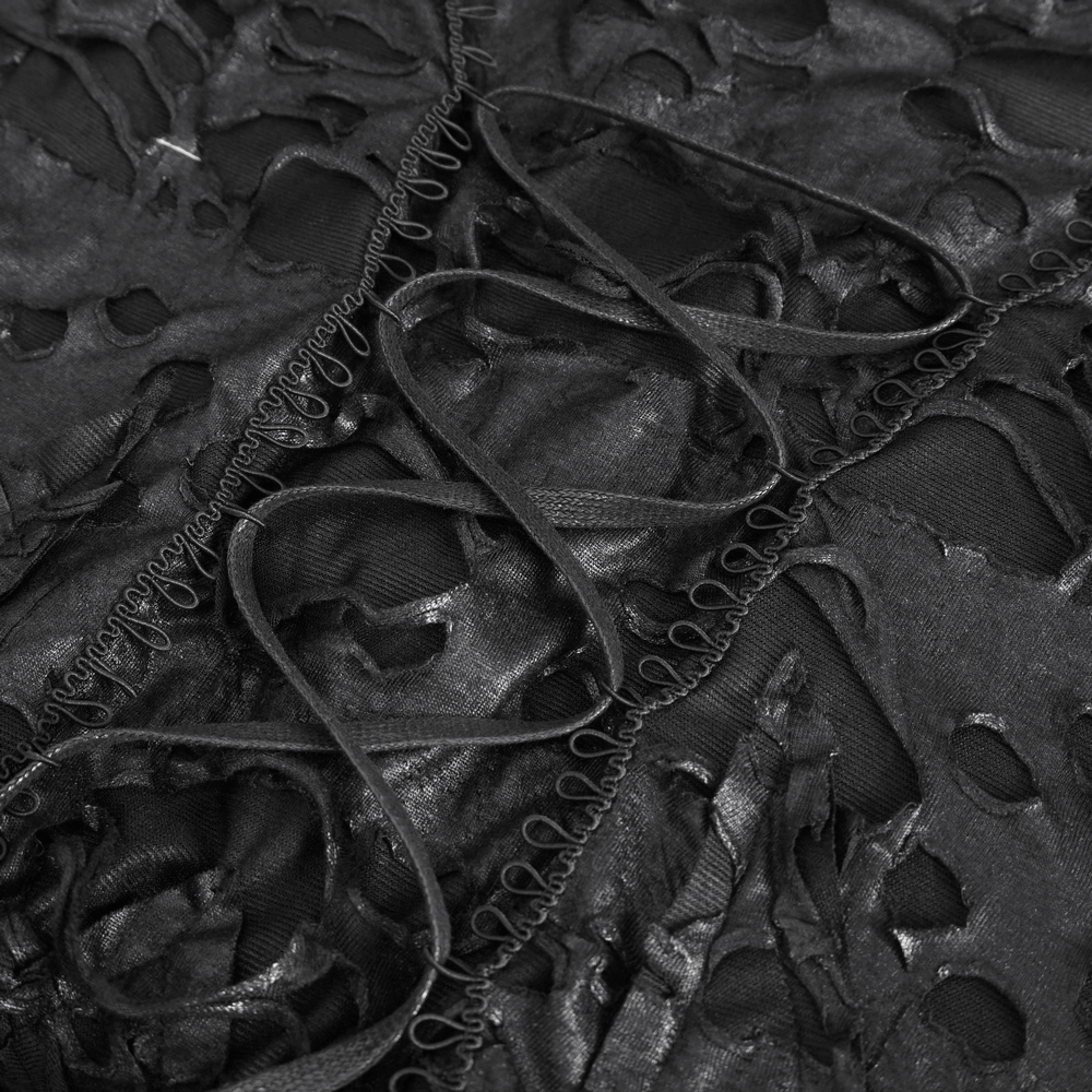 Close-up of edgy black distressed fabric showcasing unique irregular patterns and textured details.