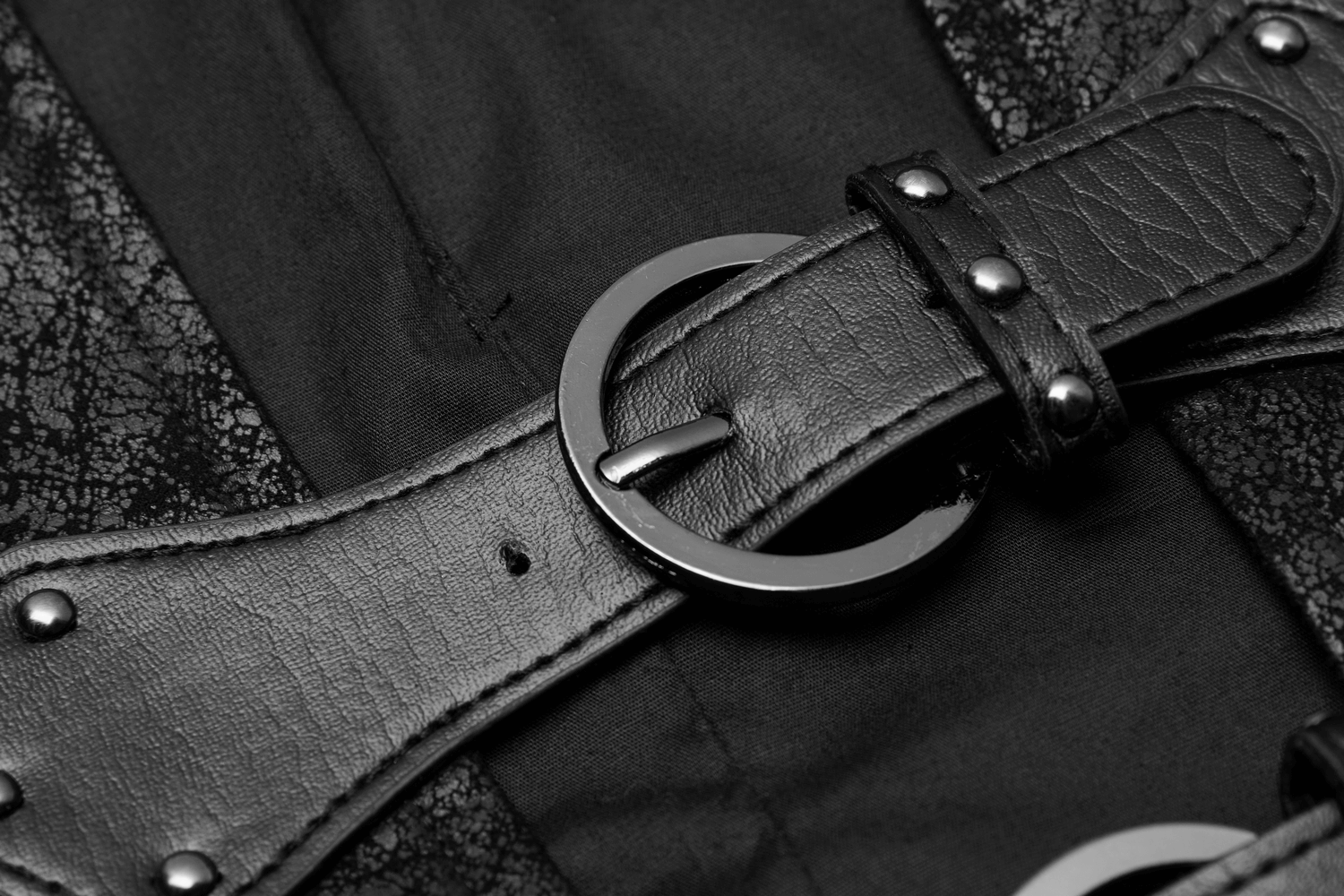Close-up of adjustable buckles on a sleek black leather vest, highlighting edgy style and versatility.