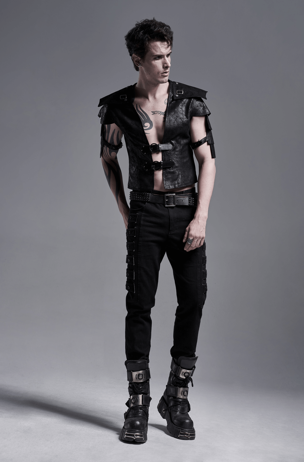 Edgy black leather vest with adjustable straps, showcasing stylish shoulder cut-outs and bold buckles.