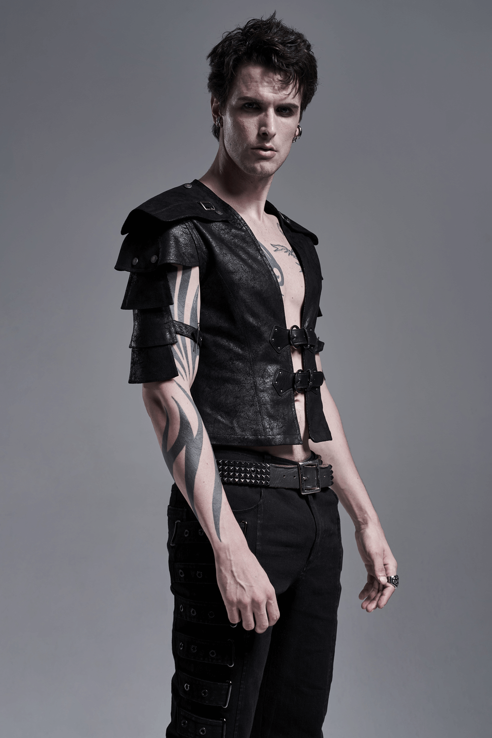 Edgy black leather vest with adjustable straps and shoulder cut-outs, showcasing a stylish and bold look.