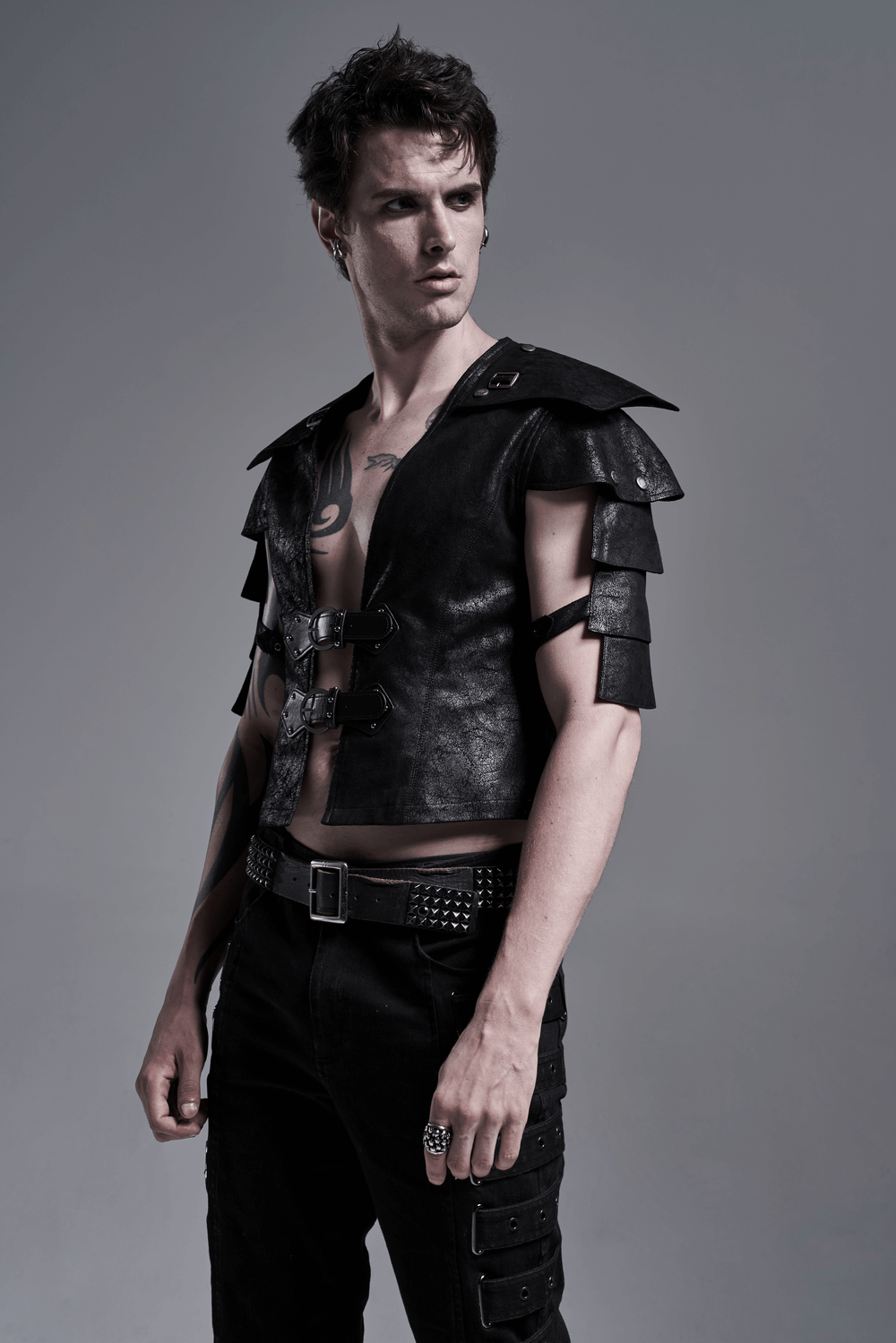 Edgy black leather vest with adjustable straps and unique shoulder cut-outs, perfect for a bold fashion statement.