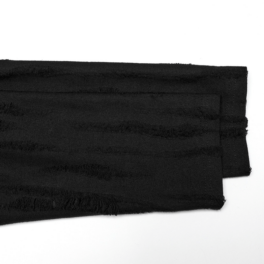 Close-up of edgy black tattered knit fabric in punk minimalist streetwear style