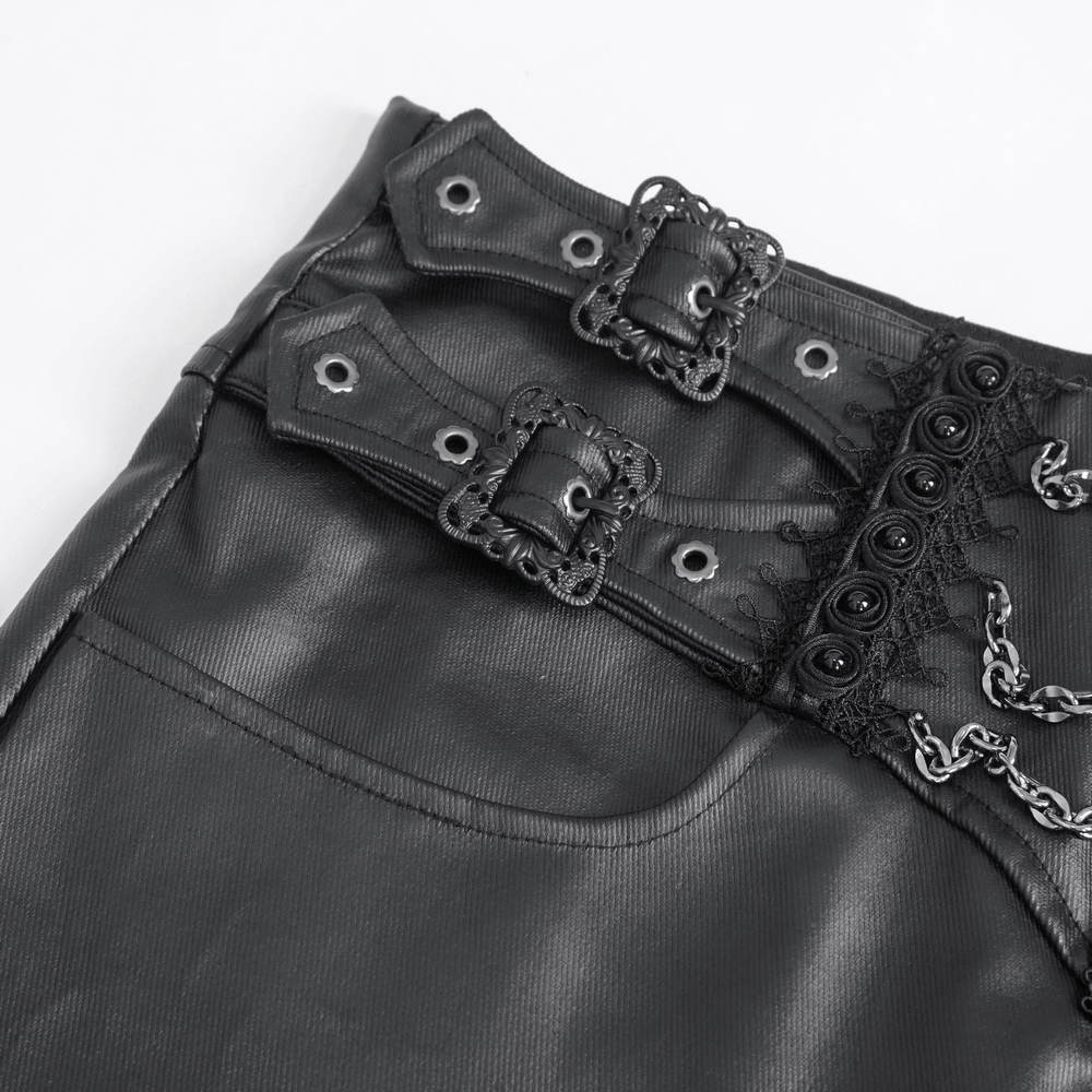 Close-up of edgy black male zippered pants featuring buckles, chains, and lace-up detailing on waistband.