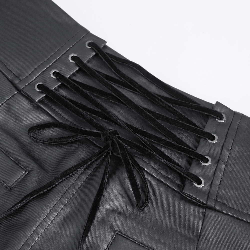 Close-up of the intricate lace-up detail on edgy black male trousers with buckles.
