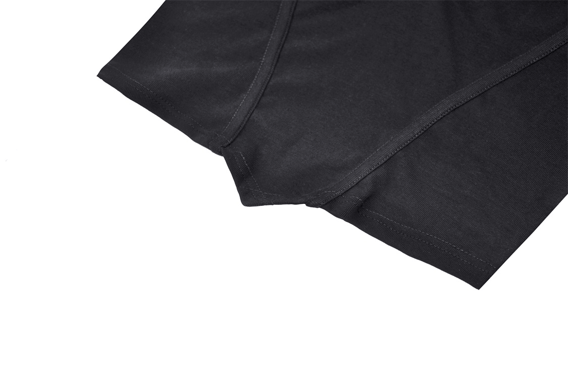 Close-up of edgy black mesh off-shoulder top showcasing fishnet details and shredded design for a modern punk style.