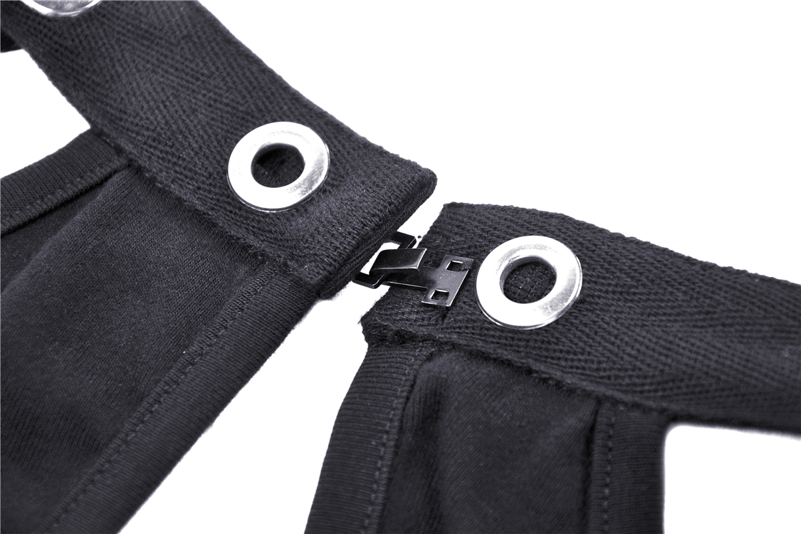 Detail of black mesh-panel crop top with strappy design and metal clasp, highlighting edgy fashion features.