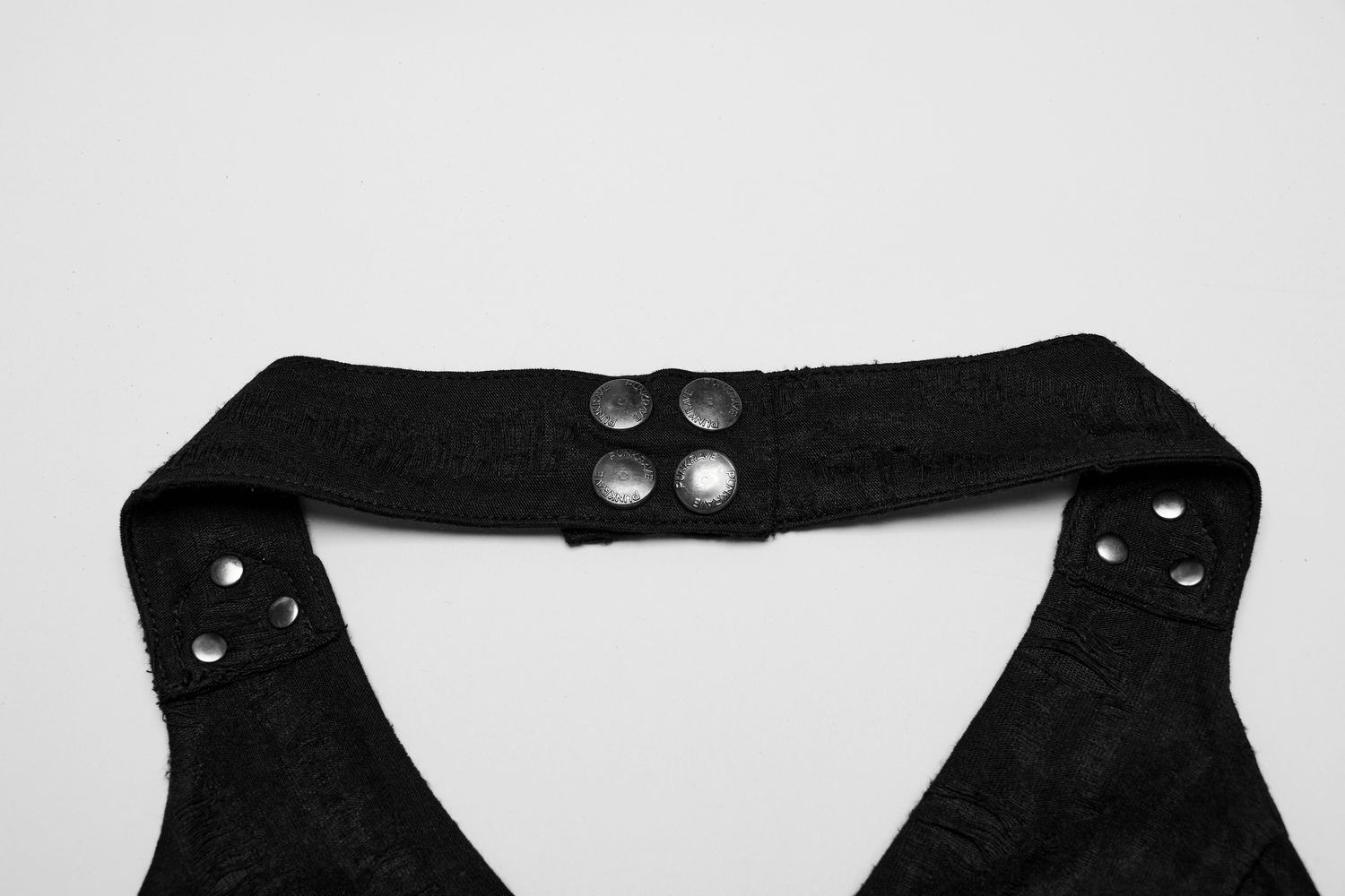 Close-up of edgy black halter top collar with snap buckles and studs for a punk rock style.