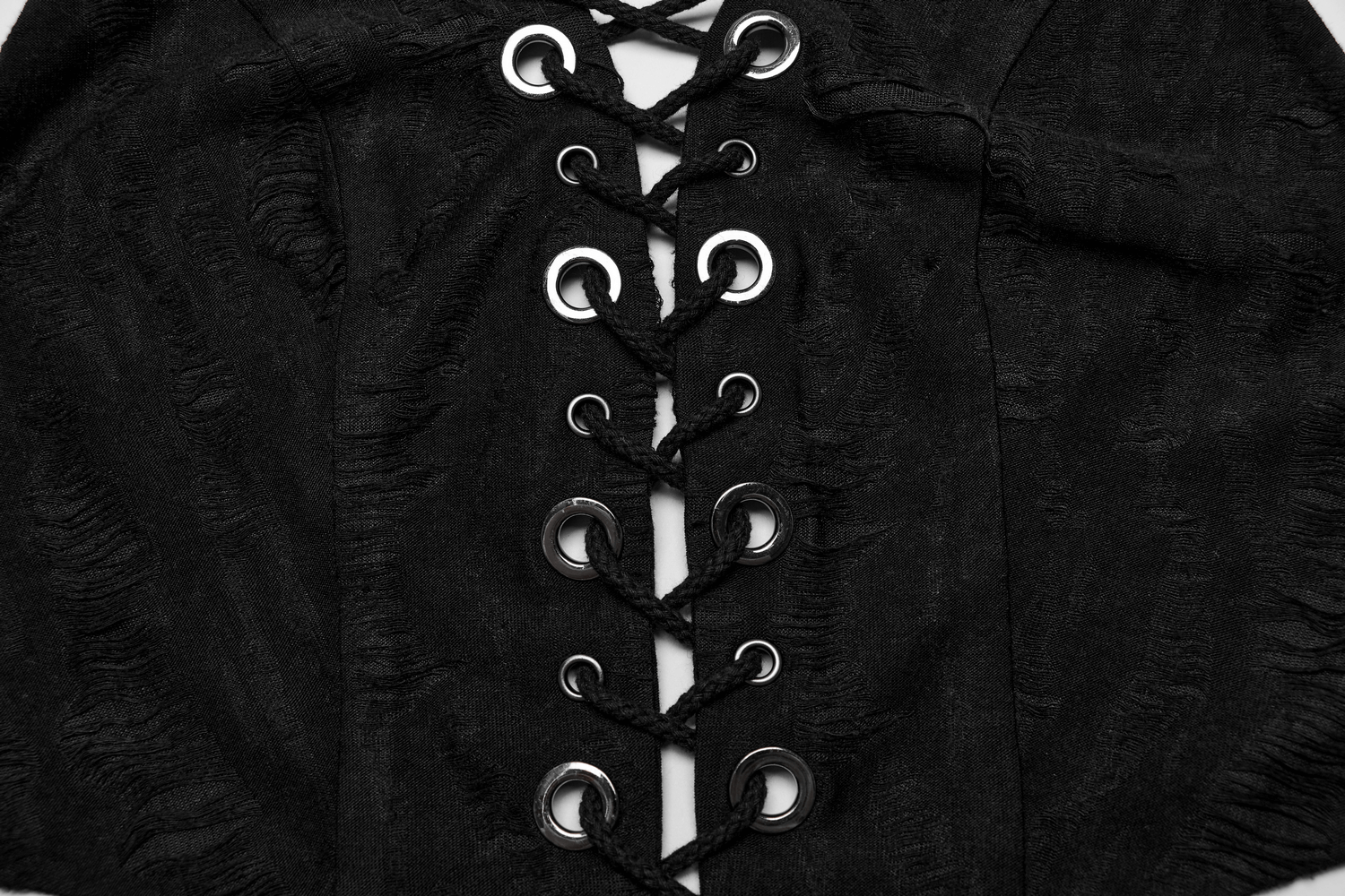 Close-up of edgy black punk halter crop top featuring lace-up front detail and tattered knit texture.