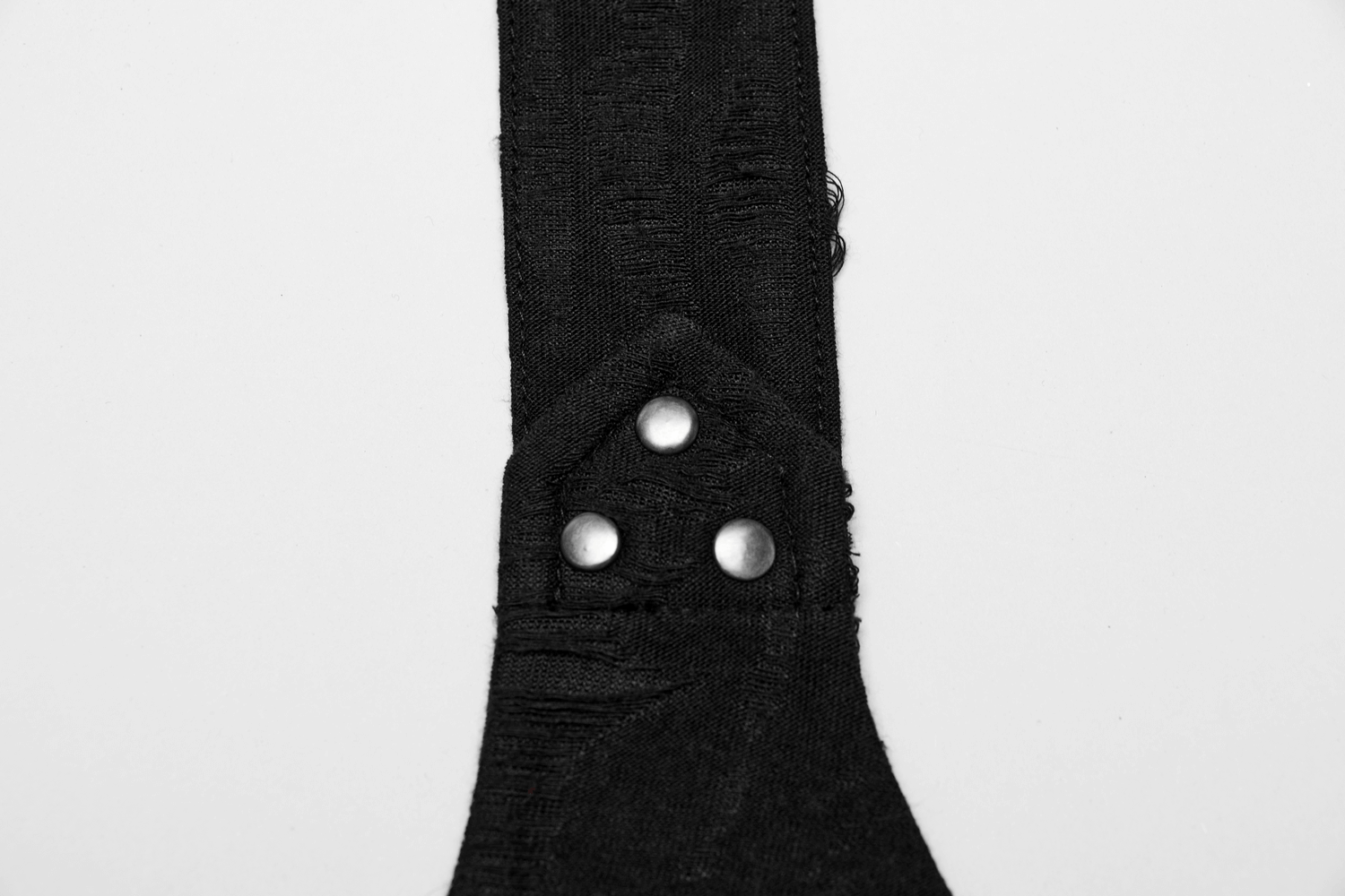 Close-up of the adjustable snap buckle detail on a black punk halter crop top.