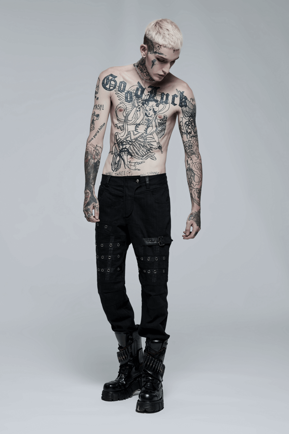 Model showcasing edgy black strap cargo pants with tattoos, ideal for punk goth streetwear style.