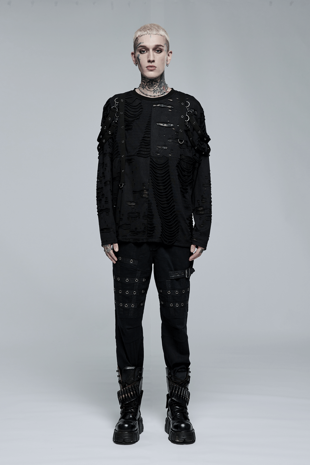 Model showcasing edgy black cargo pants and distressed top, embodying punk goth streetwear style.