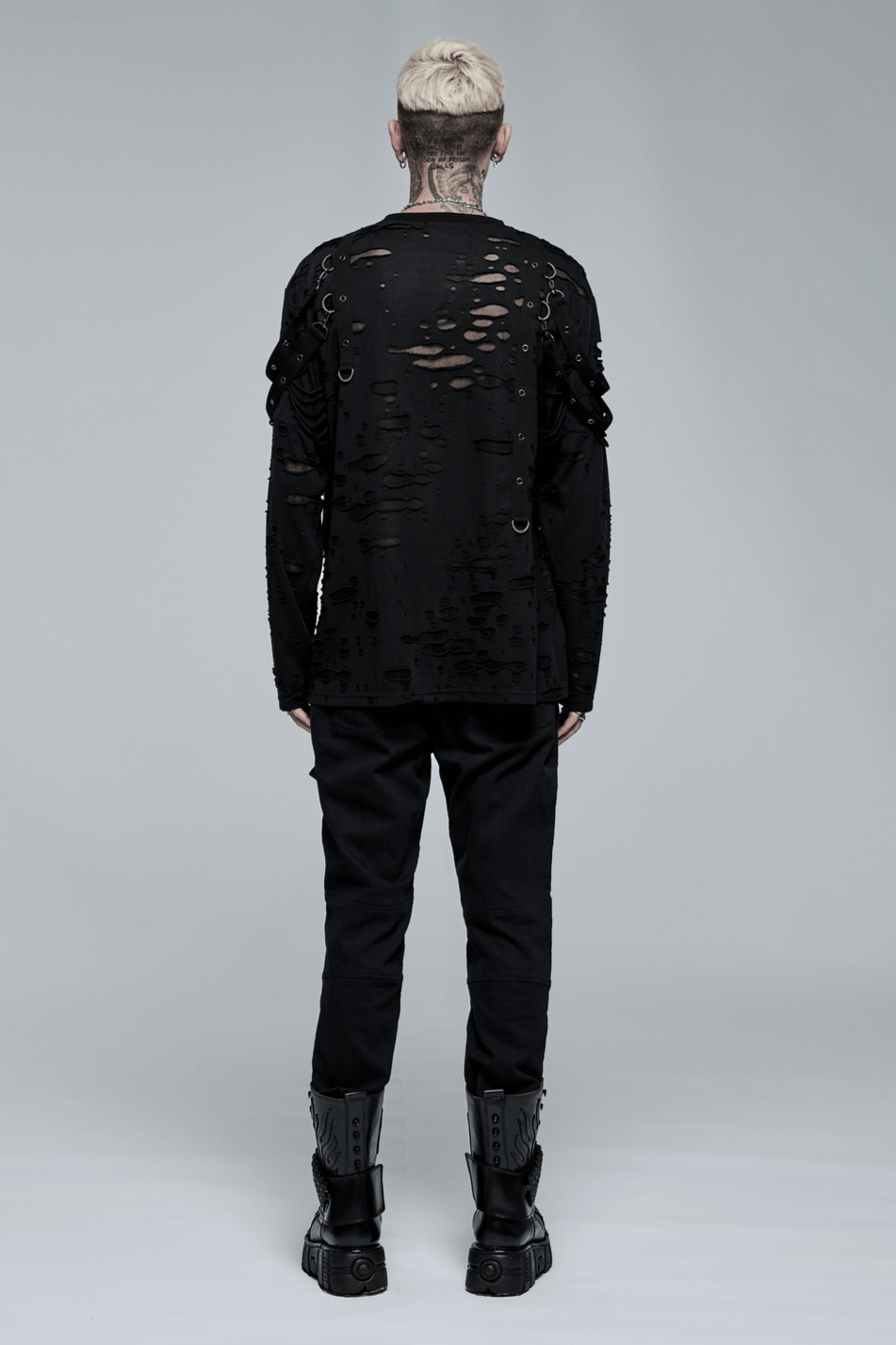 Model wearing edgy black ripped long-sleeve shirt and cargo pants, showcasing punk goth streetwear style.