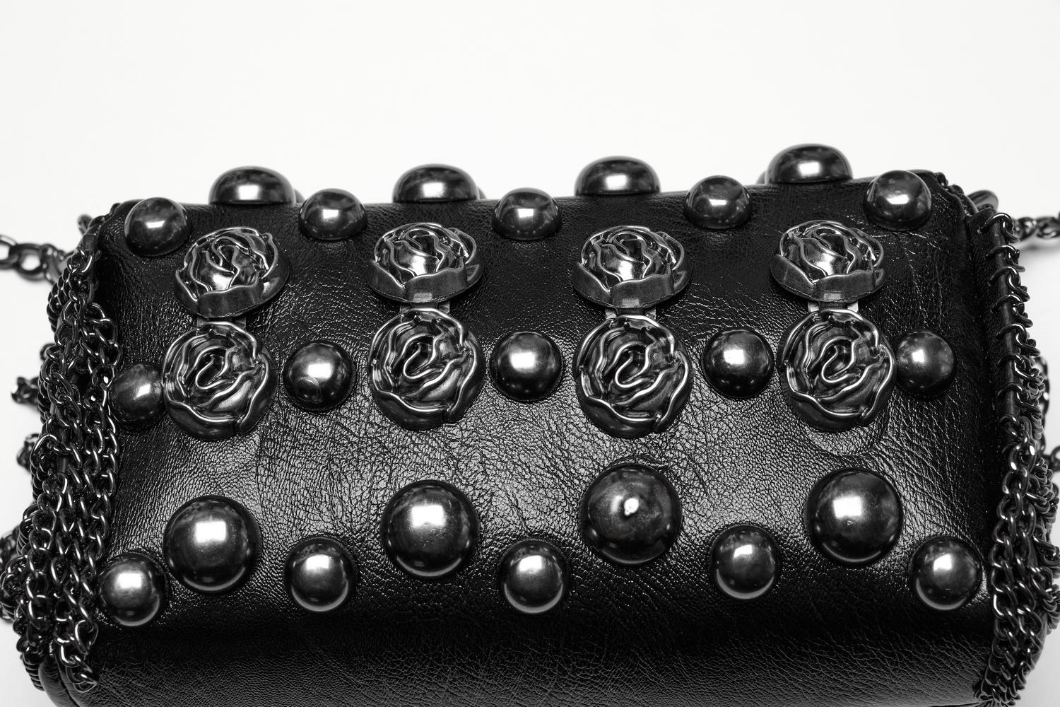 Edgy black studded crossbody bag with gothic rose rivets and metal studs, featuring striking 3D rose buckles.