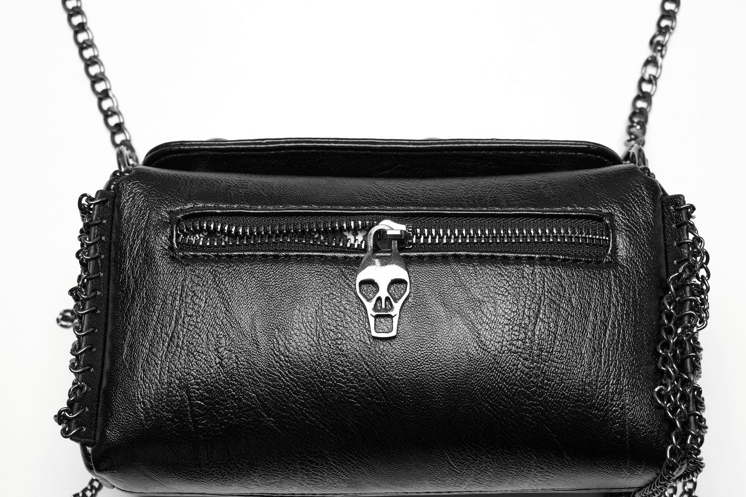 Edgy black crossbody bag featuring skull zipper, chain tassels, and gothic rose rivets for a bold fashion statement.