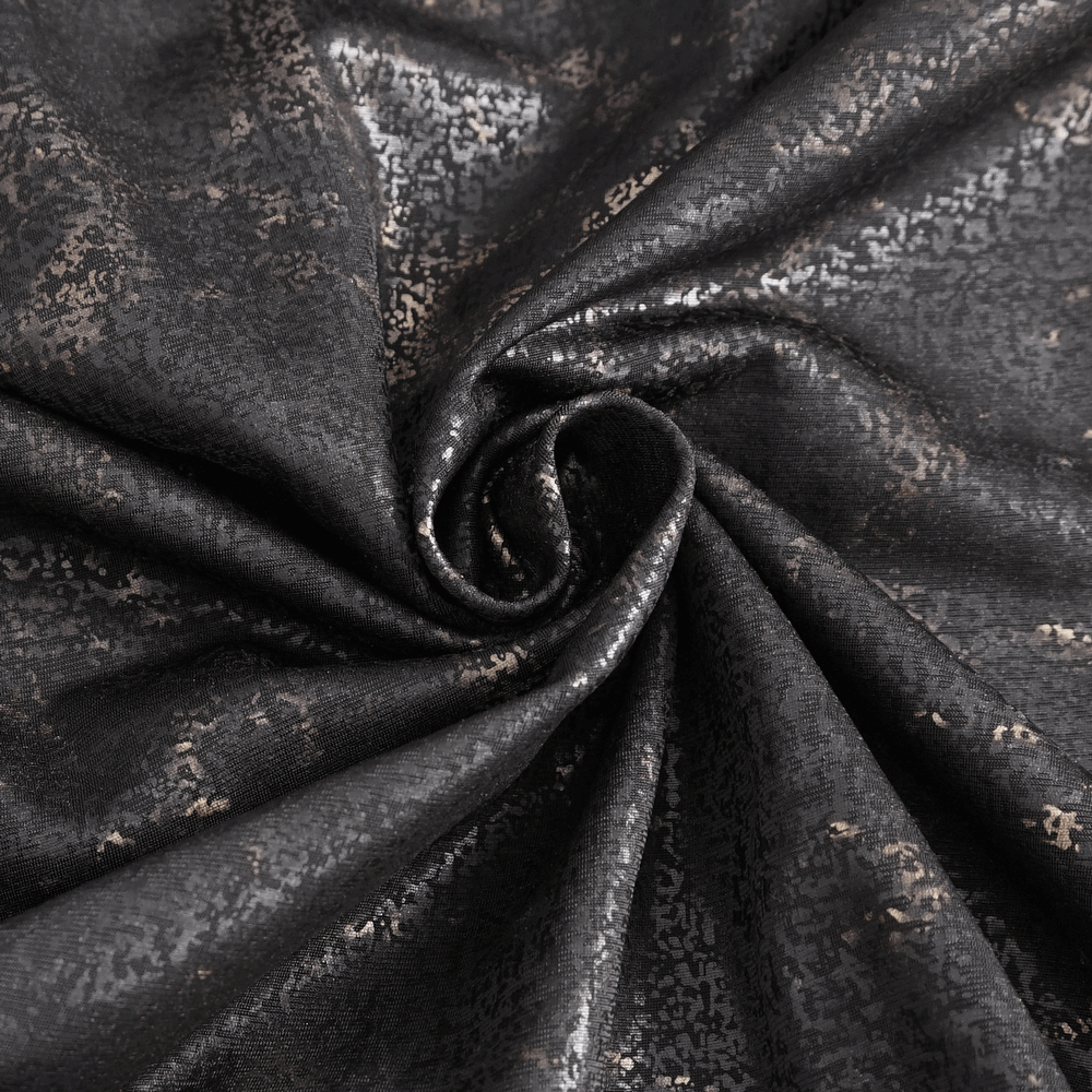 Close-up of luxurious black fabric with metallic gold print, perfect for edgy fashion statements.