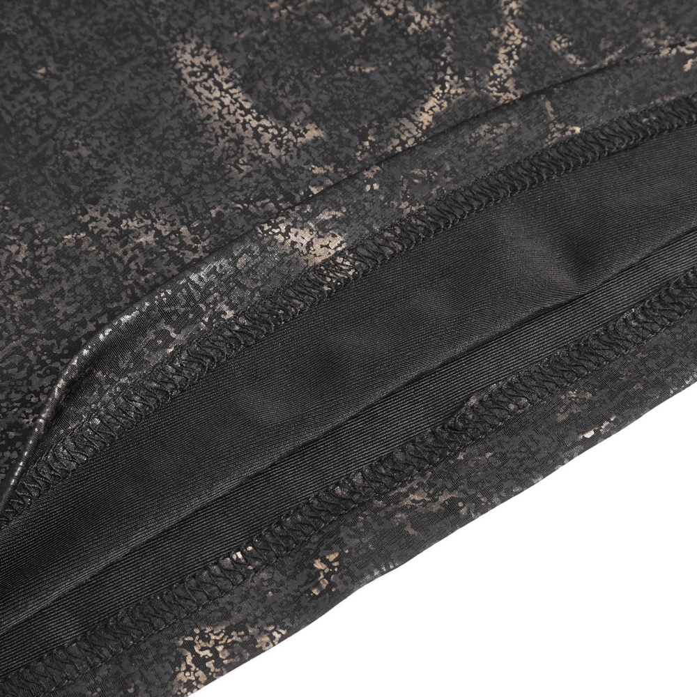 Close-up of the hem and pocket detailing on an edgy black t-shirt with gold print.