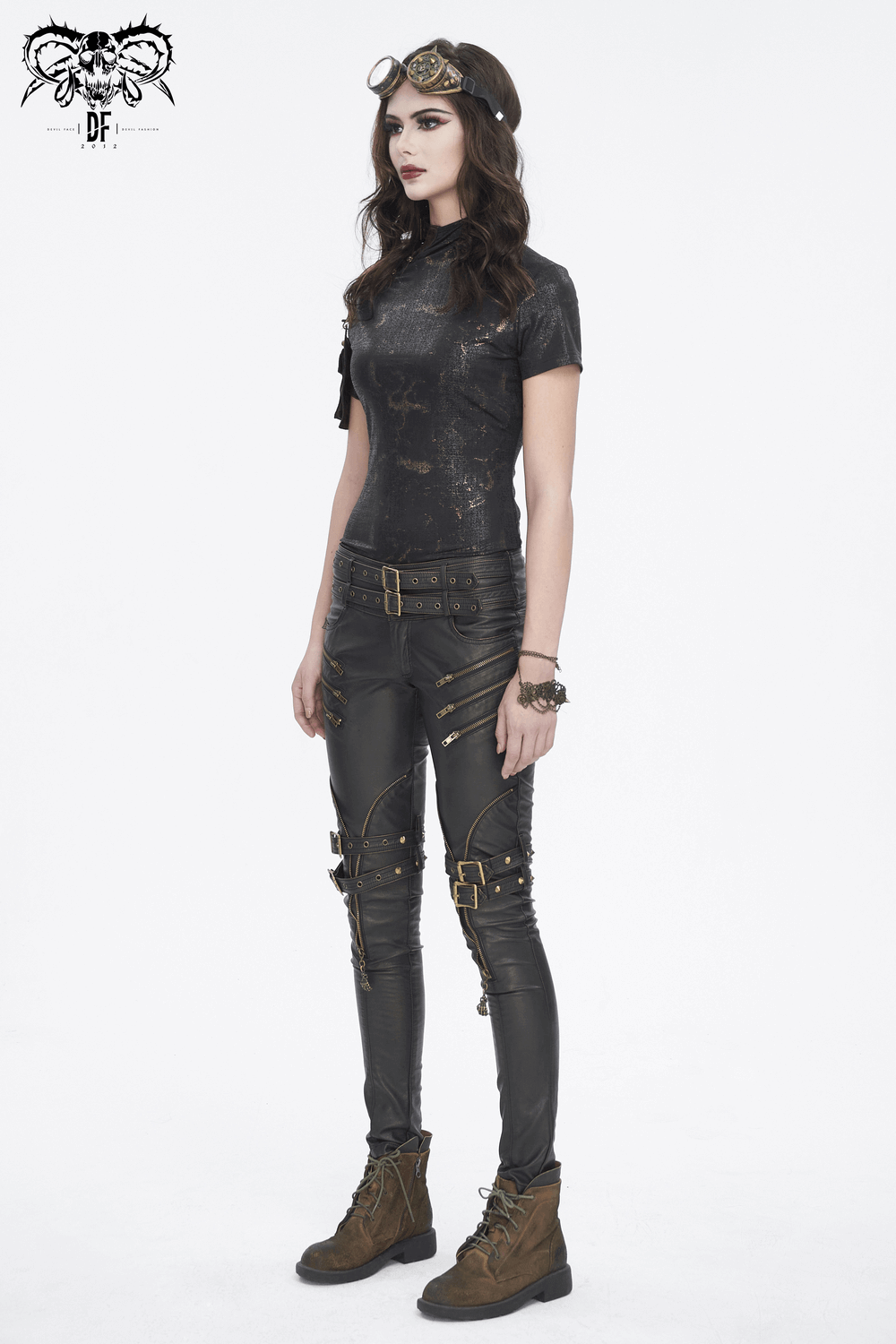Edgy black outfit featuring a stylish t-shirt, ripped pants, and trendy boots, perfect for a bold look.