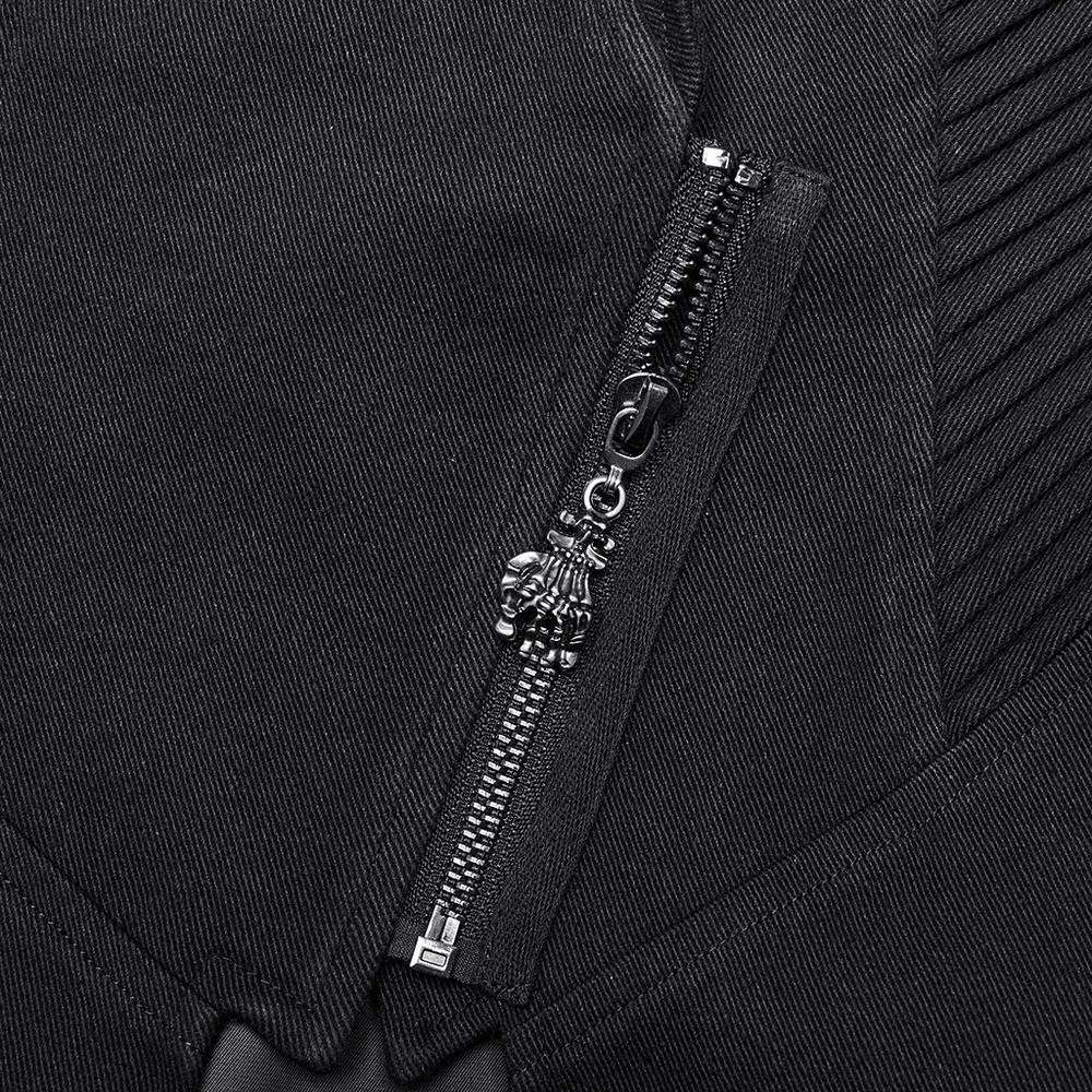 Close-up of edgy black trench coat zipper with unique skull pull and textured fabric.