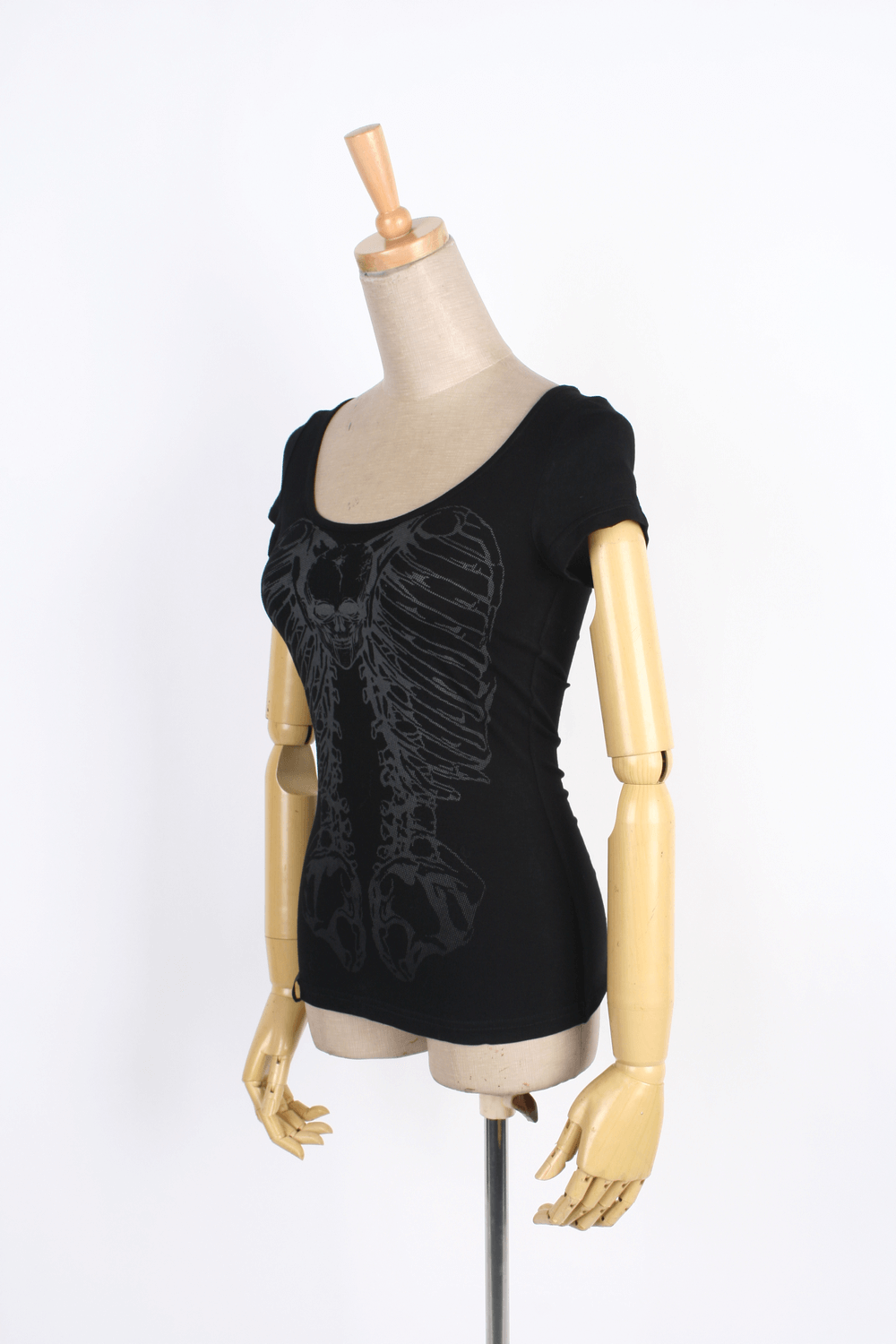 Edgy black knit t-shirt featuring a bold skeleton print, ideal for punk-inspired fashion lovers.