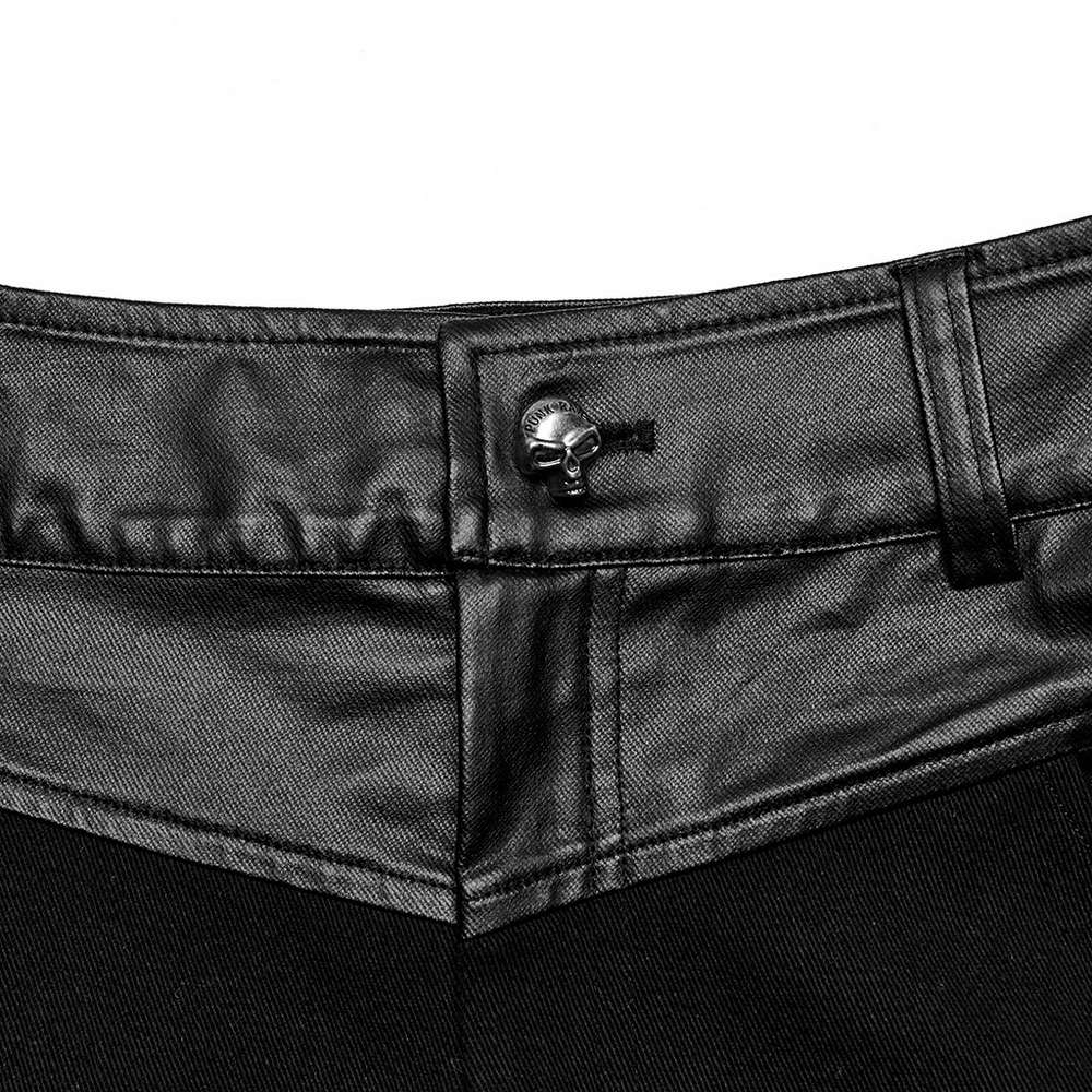 Close-up of edgy men's trousers featuring a skull button detail and rubberized waistband.