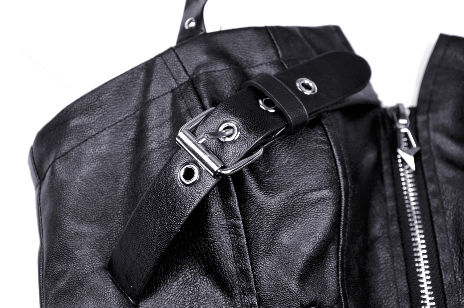 Close-up of edgy faux leather halter dress buckle and strap detail, showcasing chic gothic-inspired design.