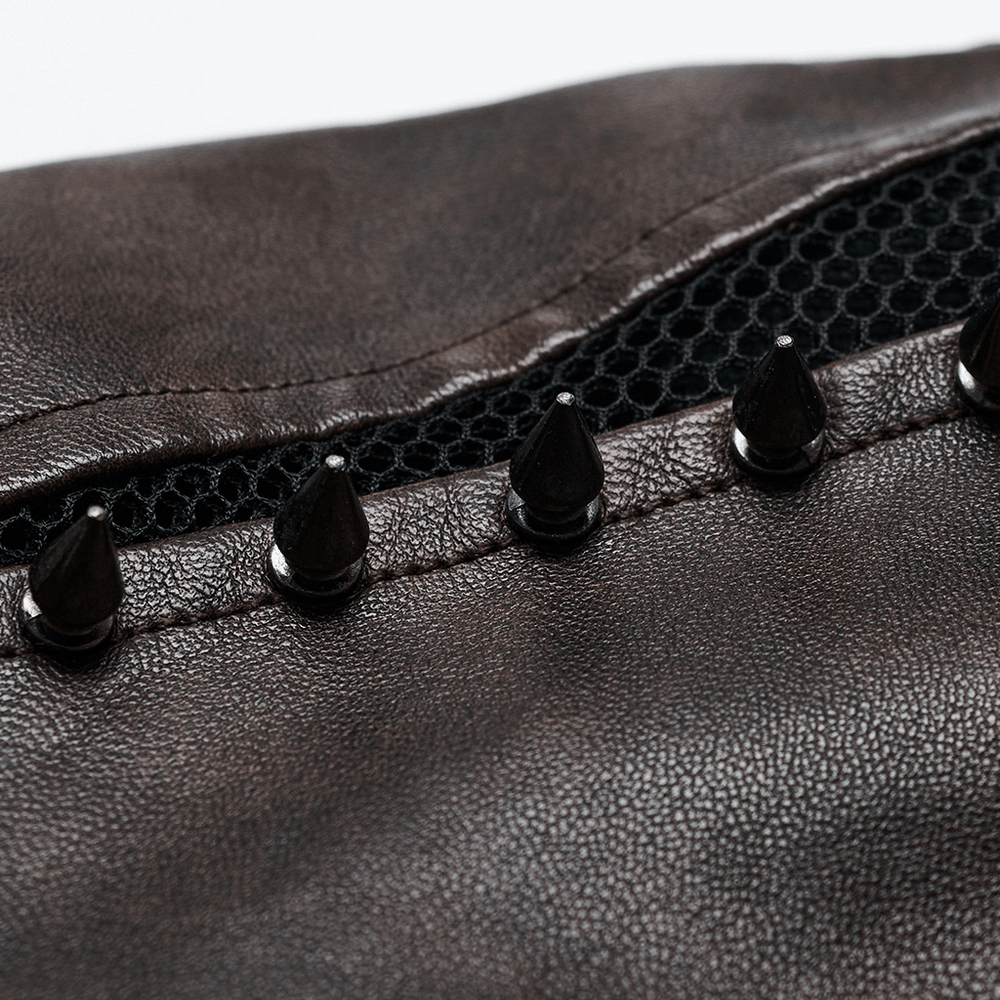 Close-up of edgy faux leather jacket with spikes and mesh cutout for punk style fashion.