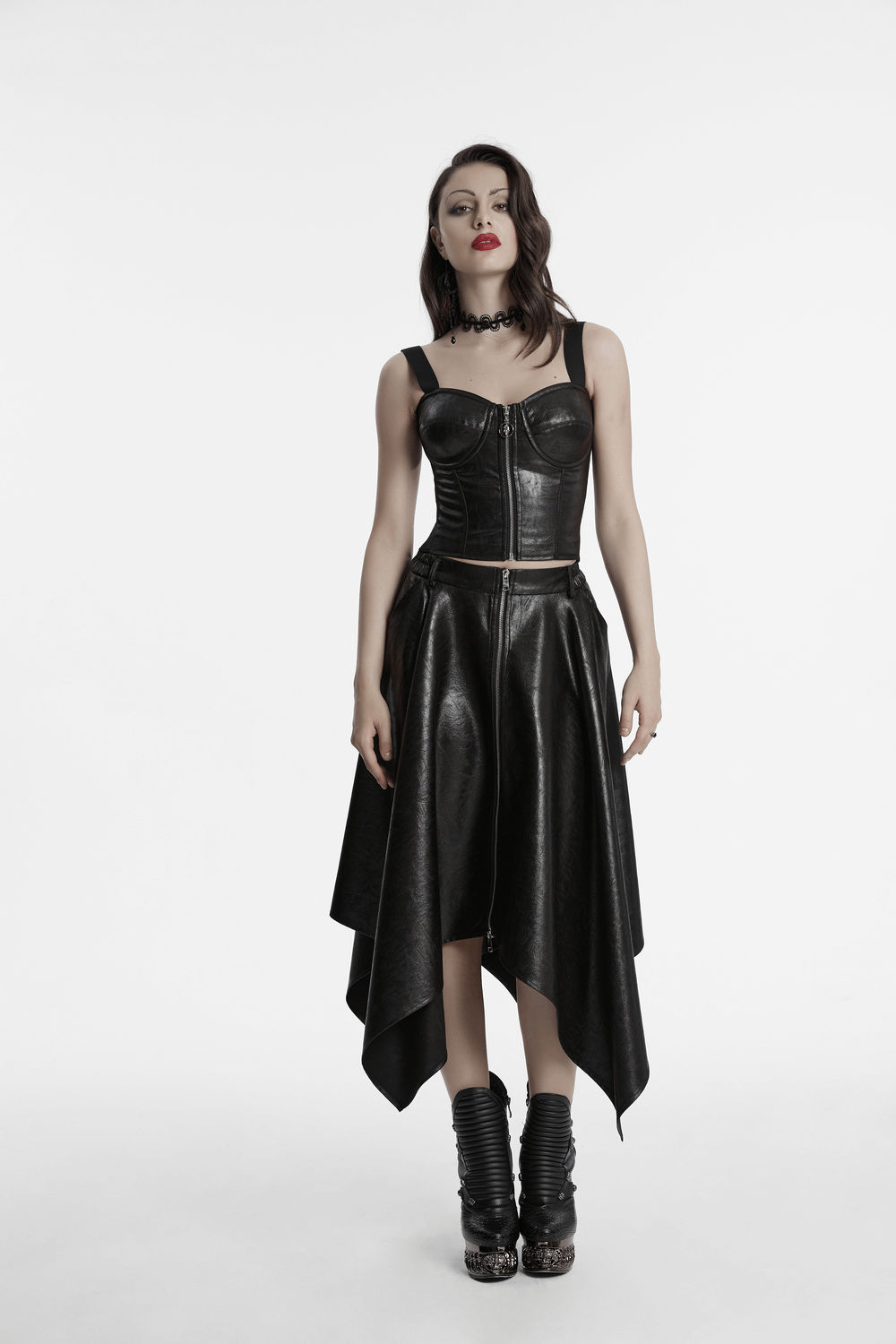 Edgy faux leather skirt featuring an asymmetrical hem and zipper detail, styled with a trendy crop top.