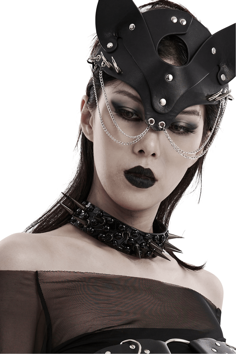 Edgy punk fashion model wearing a faux leather spiked choker and unique headpiece, showcasing a bold alternative style.
