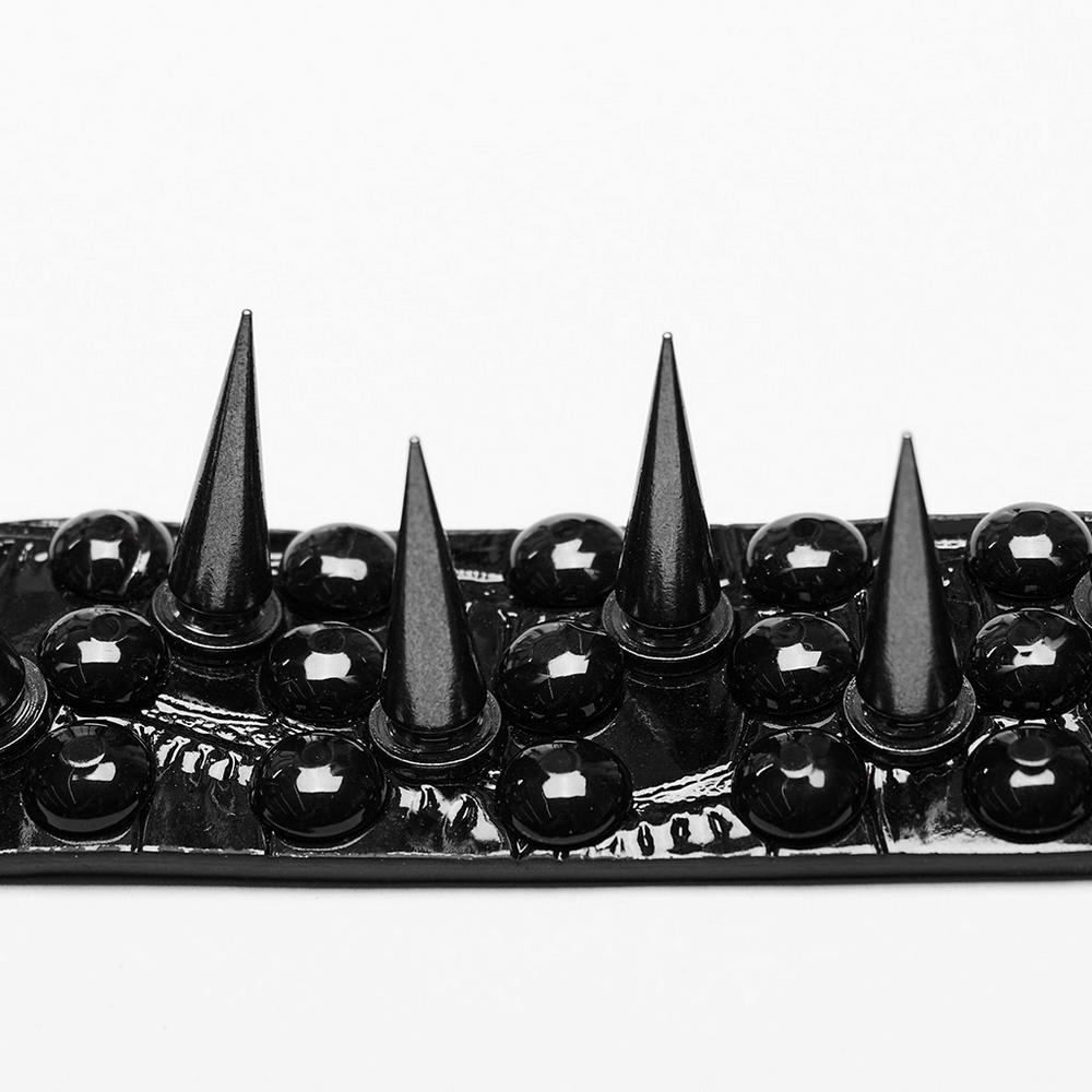 Close-up of a punk faux leather choker with shiny 3D rivets and tapered spikes, showcasing edgy design elements.