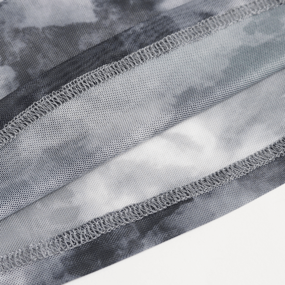 Close-up of edgy grey and white tie-dye fabric showcasing unique texture and stitching details.