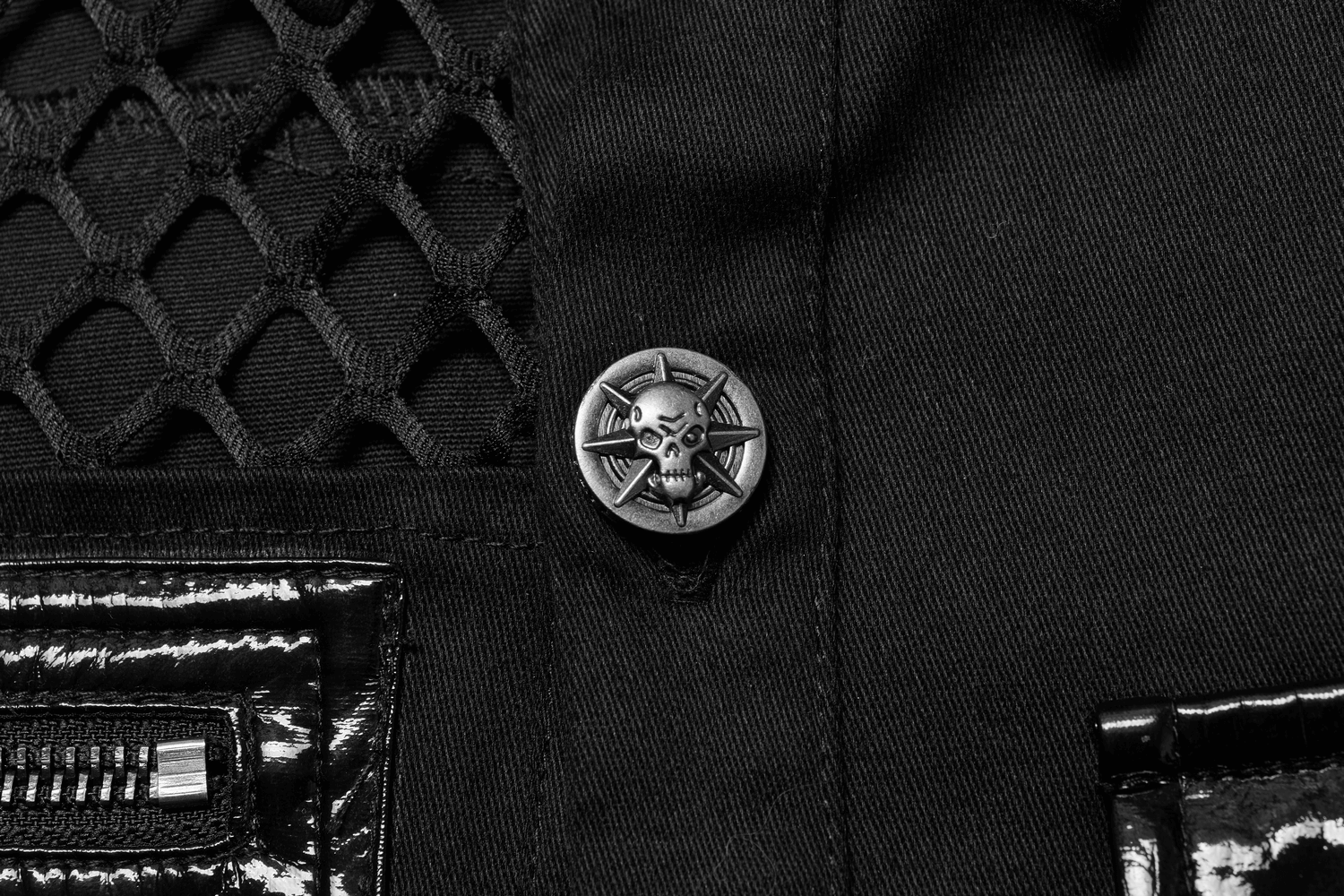 Close-up of edgy fishnet detail and unique skull button on gothic shirt.