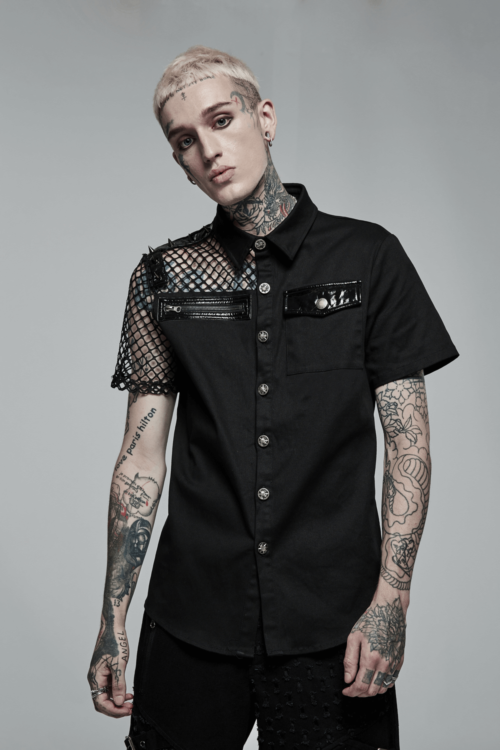 Model wearing Edgy Fishnet Sleeves Button-Up Gothic Shirt with punk stitch and patent leather accents.