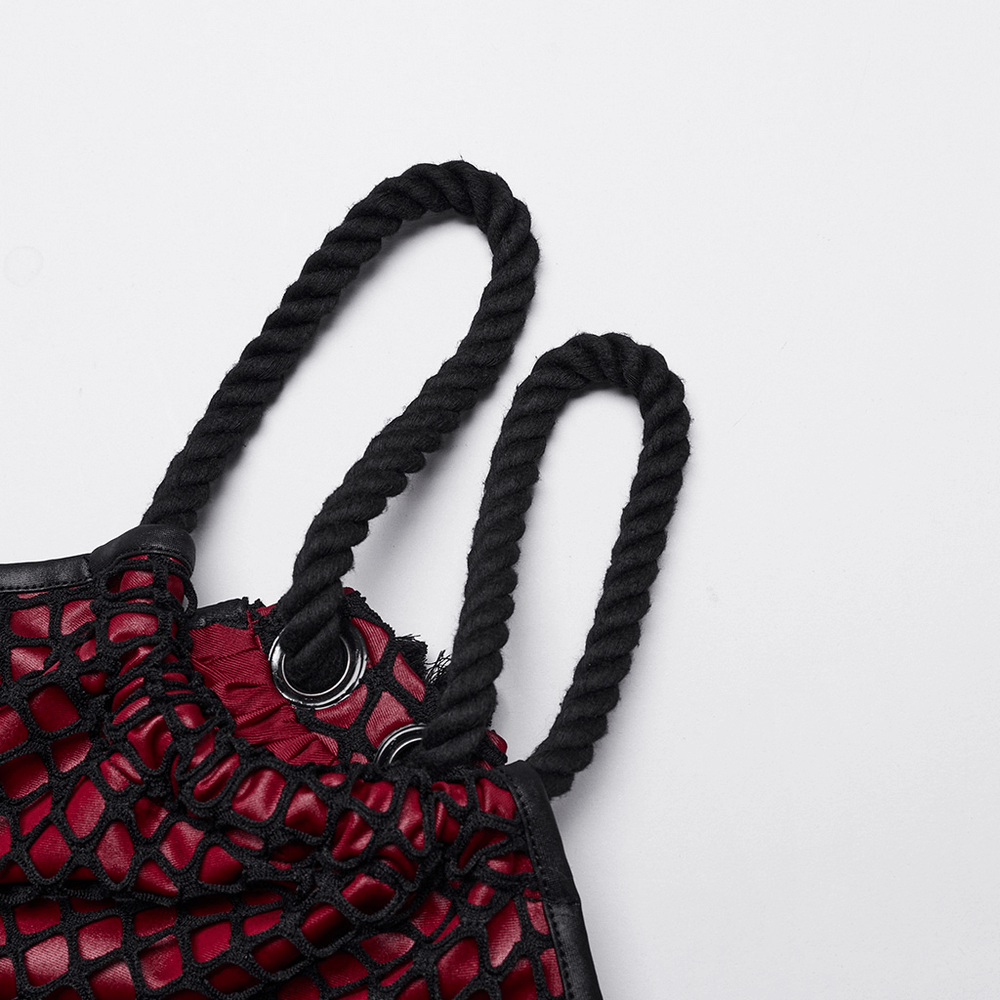 Close-up of edgy gothic dress shoulder straps featuring black mesh and distinctive thick round design.