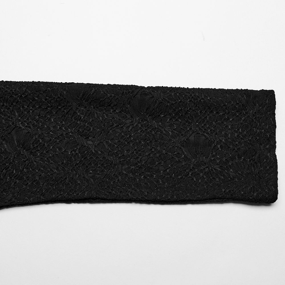 Close-up of elegant black 3D jacquard fabric, showcasing intricate textured design for goth fashion.