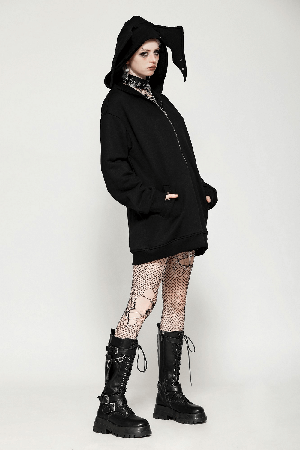 Edgy Gothic batwing zip-up hoodie with bat ears, worn by a model in fishnet tights and combat boots, showcasing unique style.