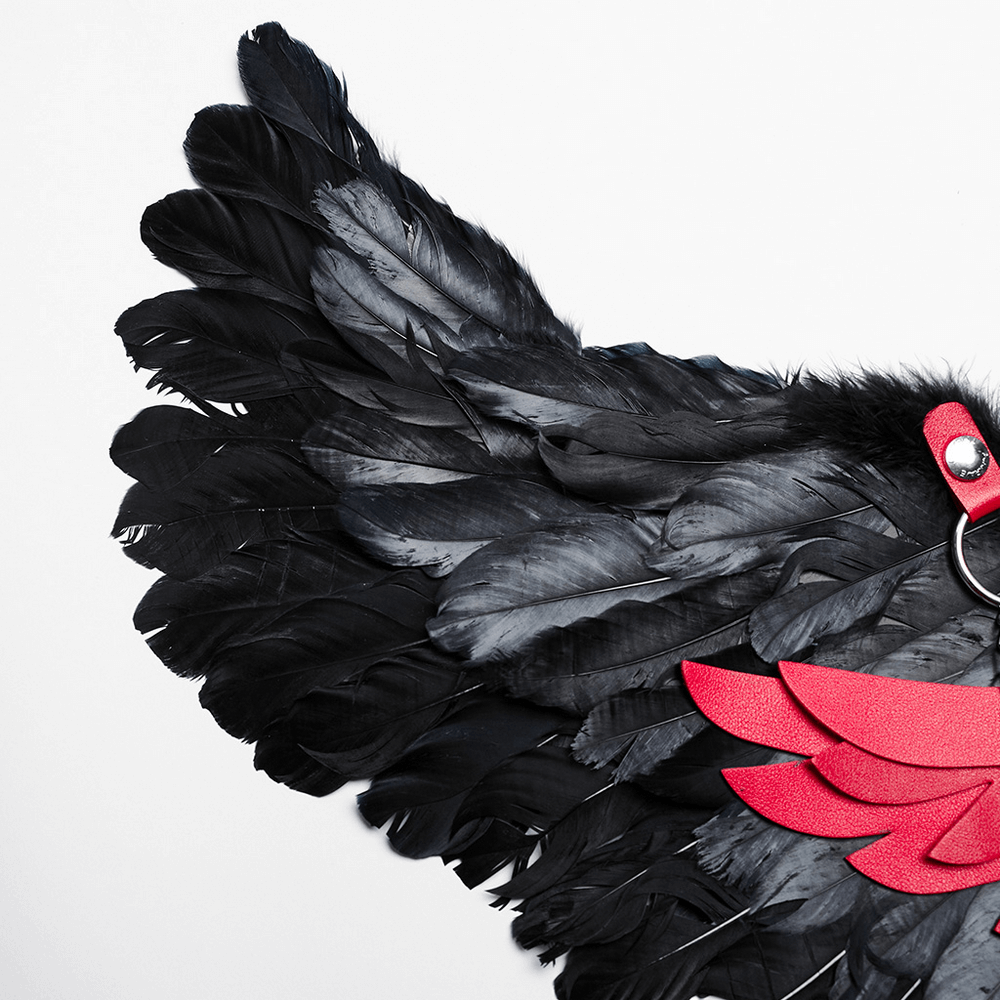 Close-up of edgy gothic black raven feather wings with red accents, perfect for punk and dark fashion.